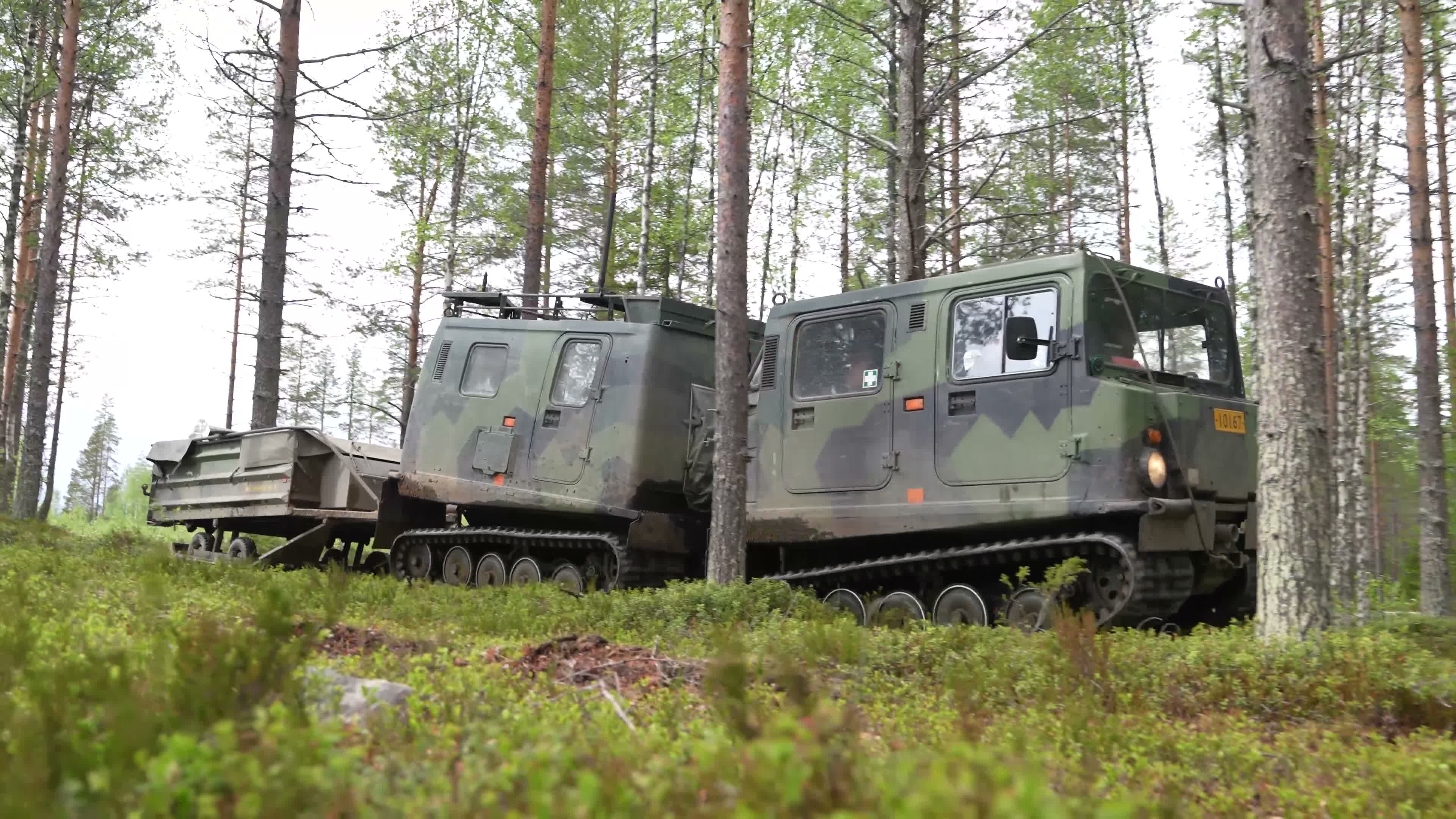 010626 FINNISH SOLDIERS MOVE THROUGH THE FOREST WITH BANDVAGN TRACKED ARTICULATED ALL-TERRAIN VEHICLES CREDIT NATO