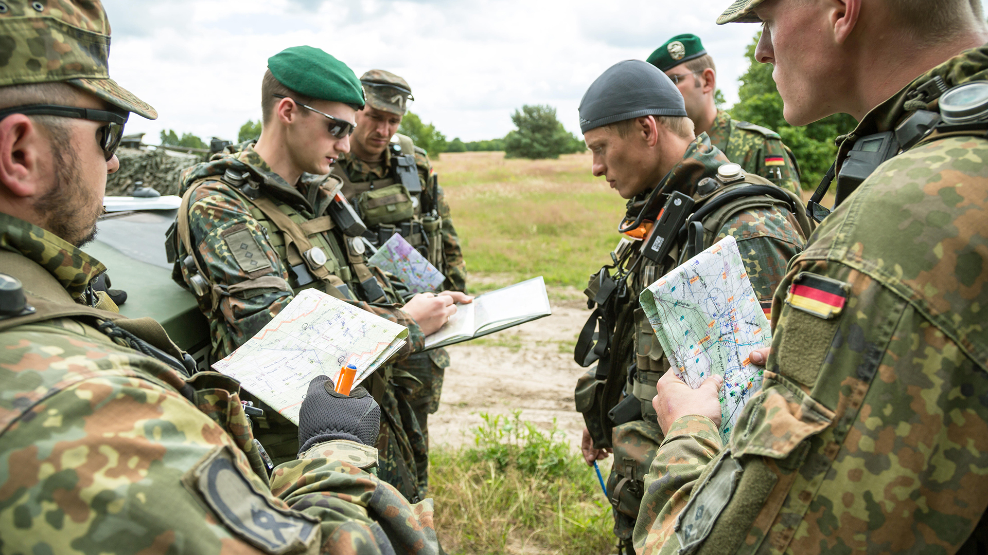  These mechanised infantry soldiers holding an O Group are wearing the temperate Flecktarn camo