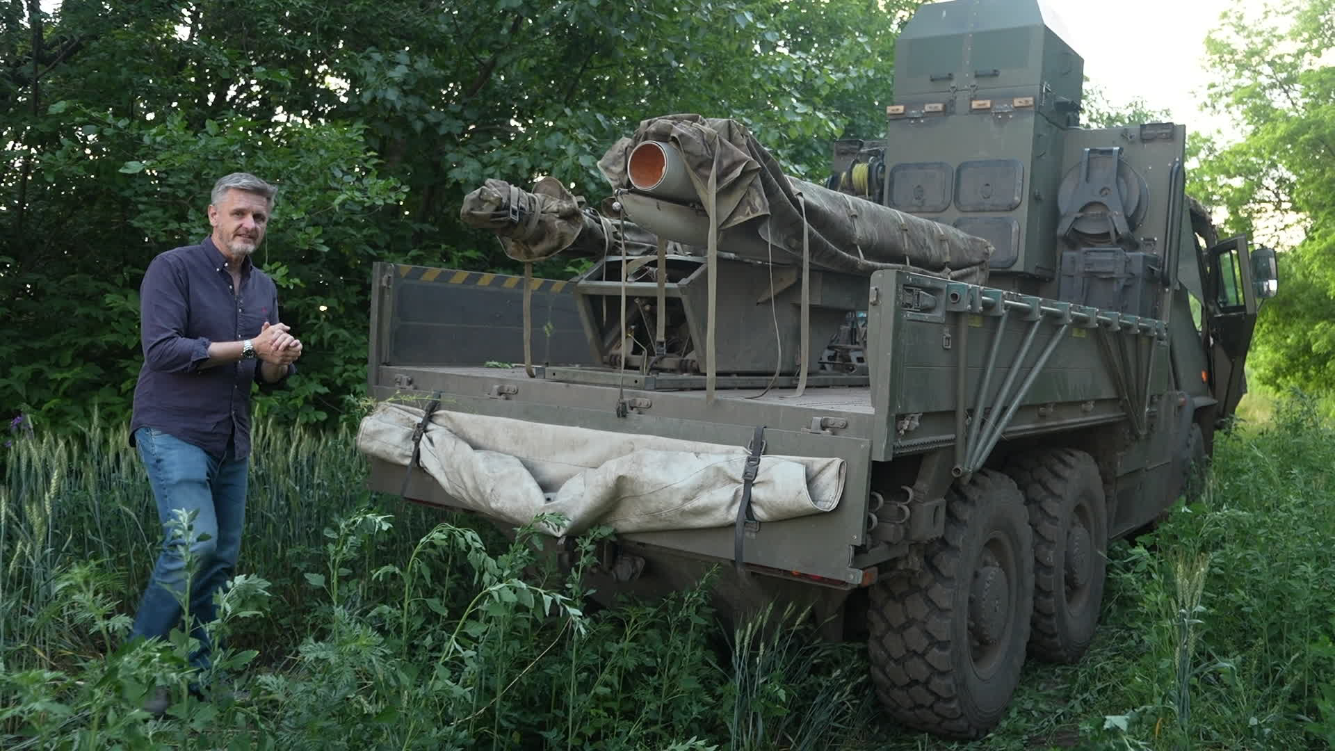BFBS Forces News reporter shows off the rail and ASRAAM missile system mounted in the flat bed of a Supacat (Picture: BFBS)