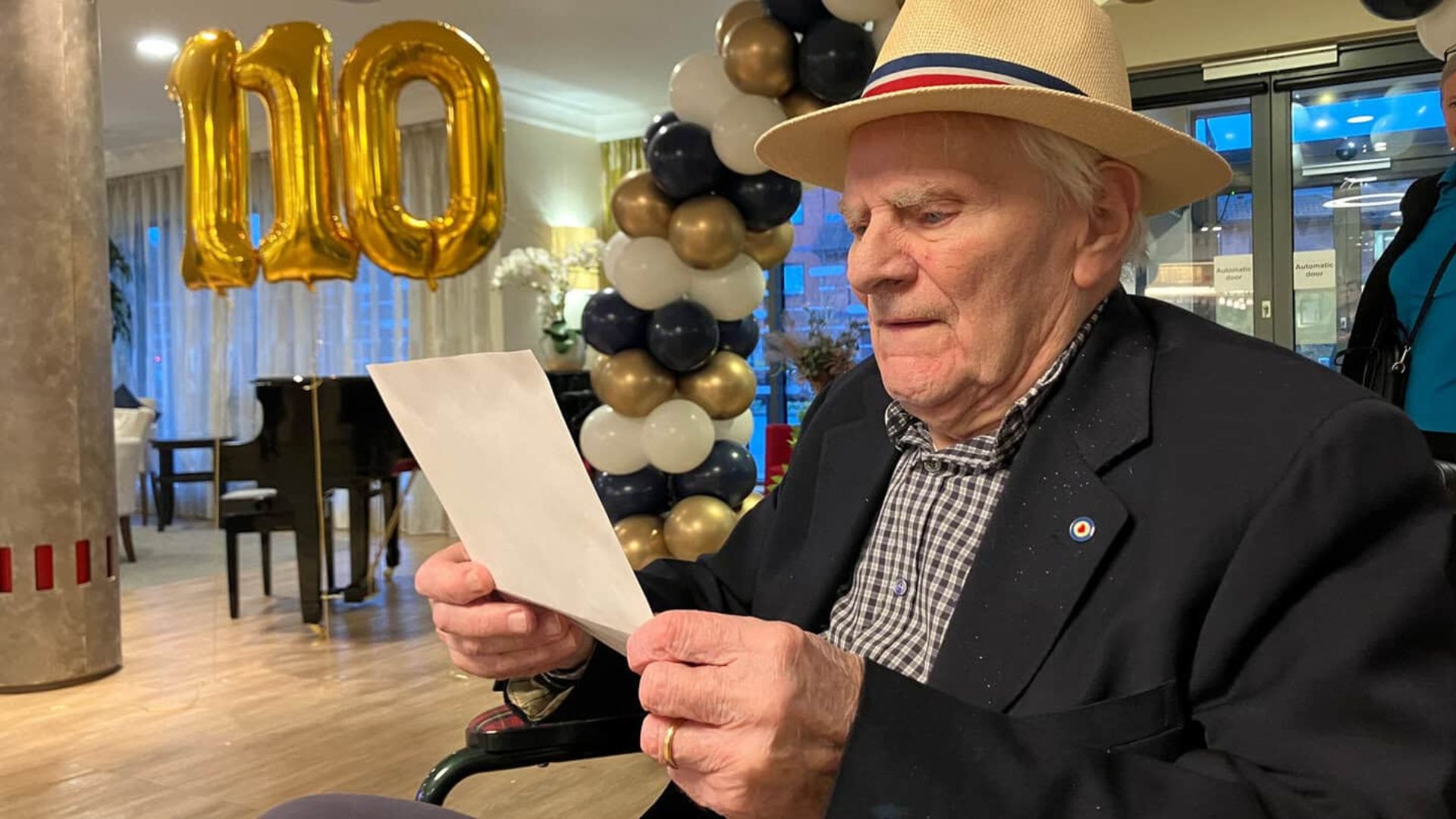Norman, an RAF veteran, reads a letter from Princess Anne, Patron of the charity