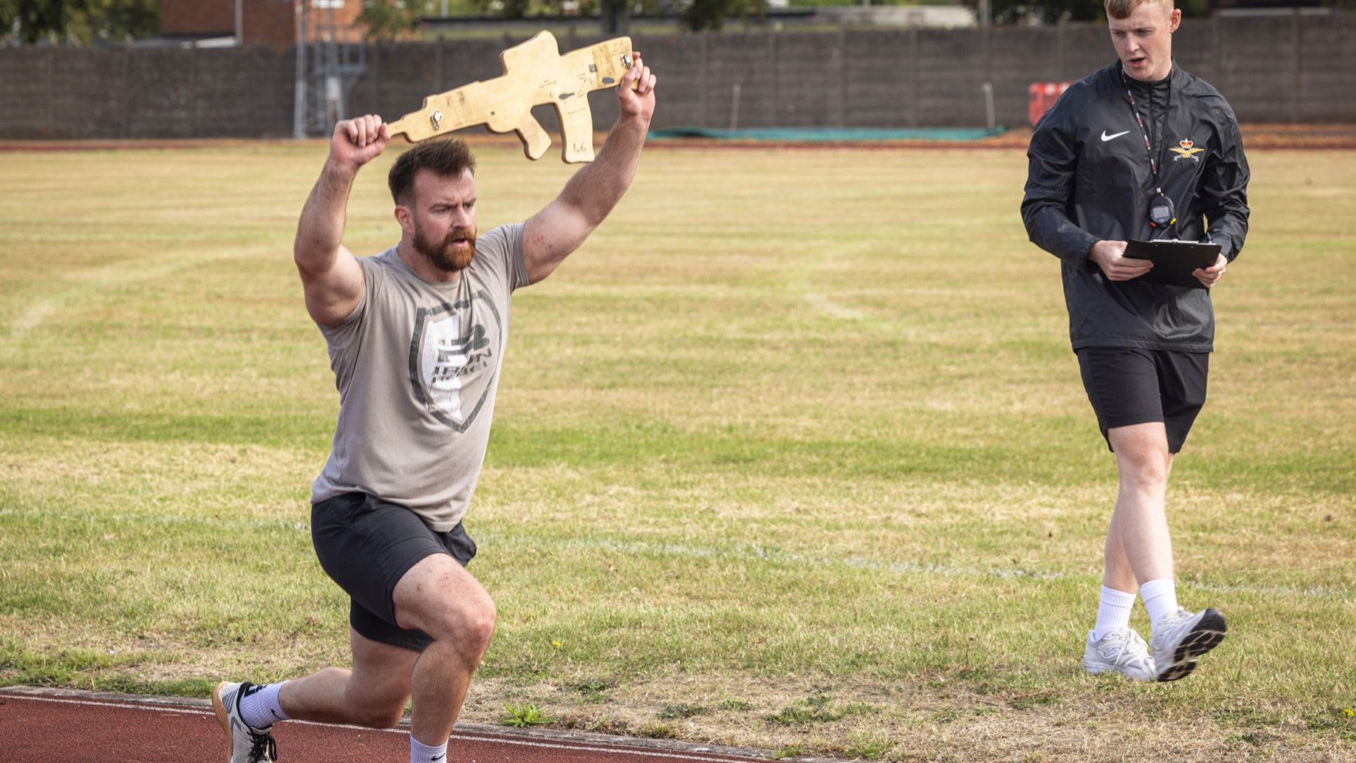 After two laps of the running track, the athletes then had to perform lunges carrying a wooden rifle overhead (Picture: RAF)