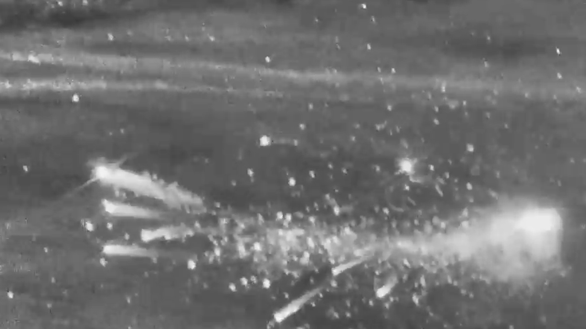 After the blast, the damaged drone, seen on the left, leaves a fiery trail in its wake