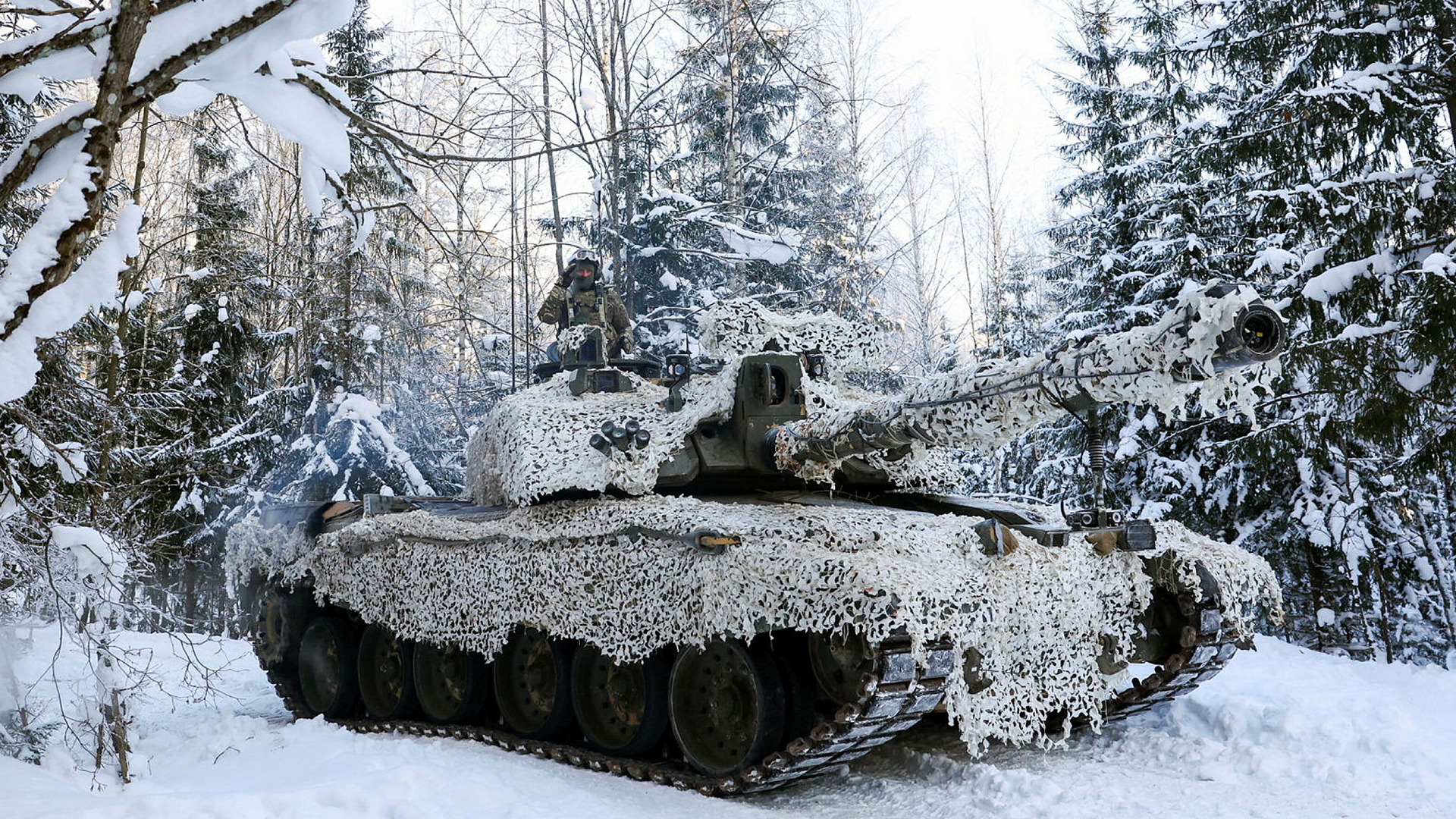 This Royal Tank Regiment Challenger 2 is almost unrecognisable in the winter snow in Estonia thanks to the cam net that covers almost the entire vehicle (Picture: MOD)