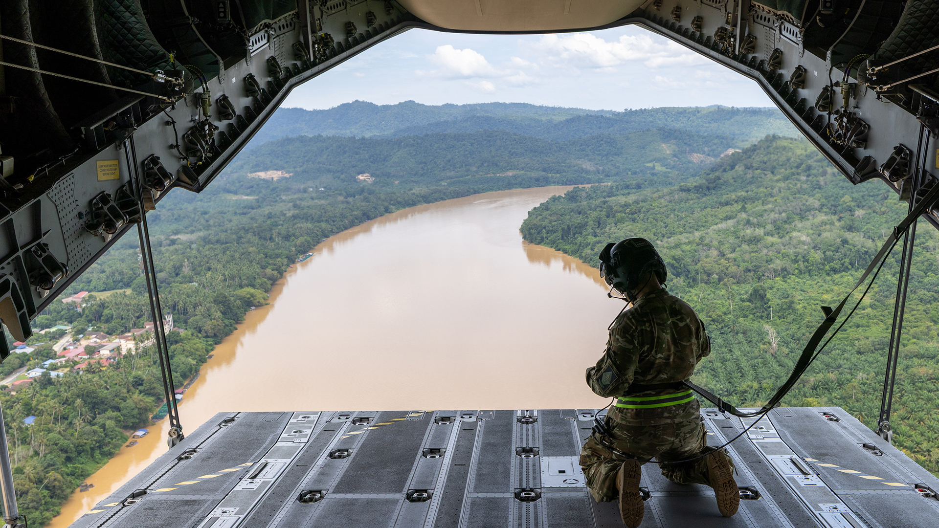 The Malaysian jungle is laid out below as the loadmaster on the RAF Atlas surveys the ground