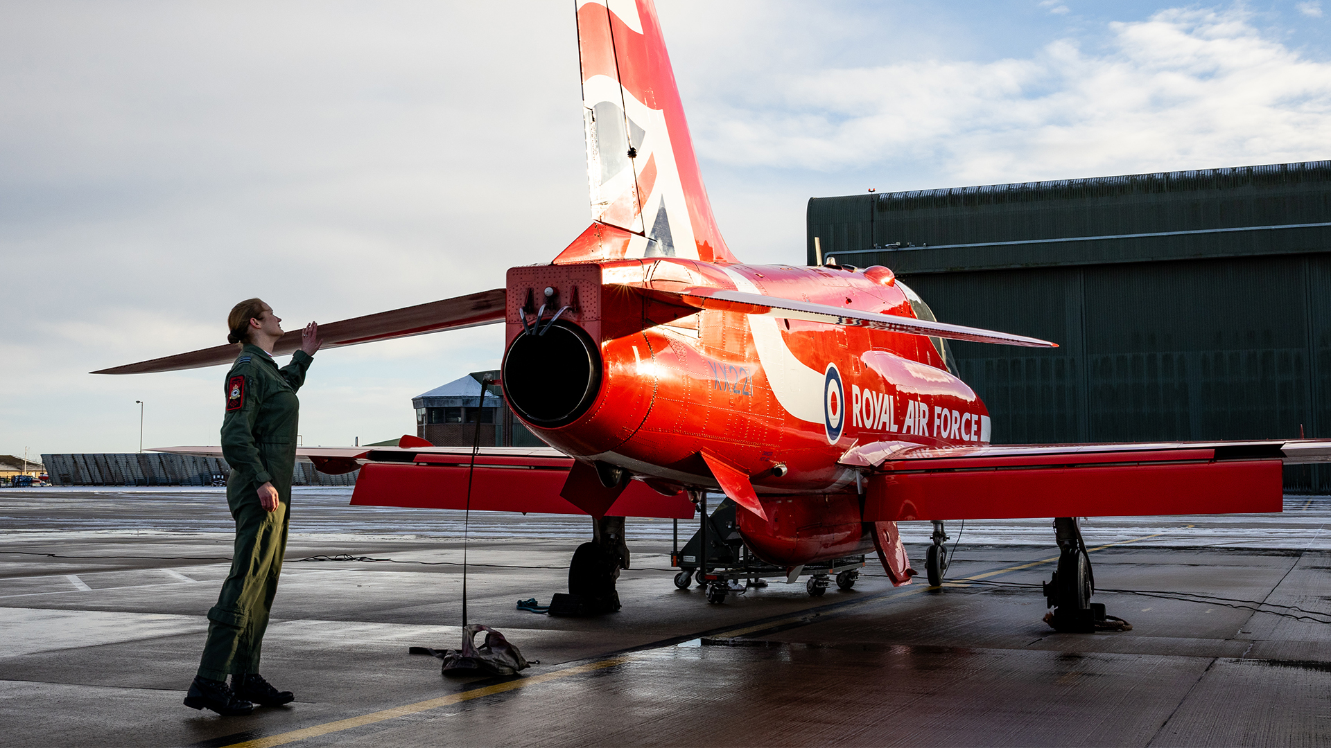 Wing Commander Sasha Nash, the Officer Commanding of the Red Arrows, inspects the tail of one of the Hawk jets (Picture: MOD)