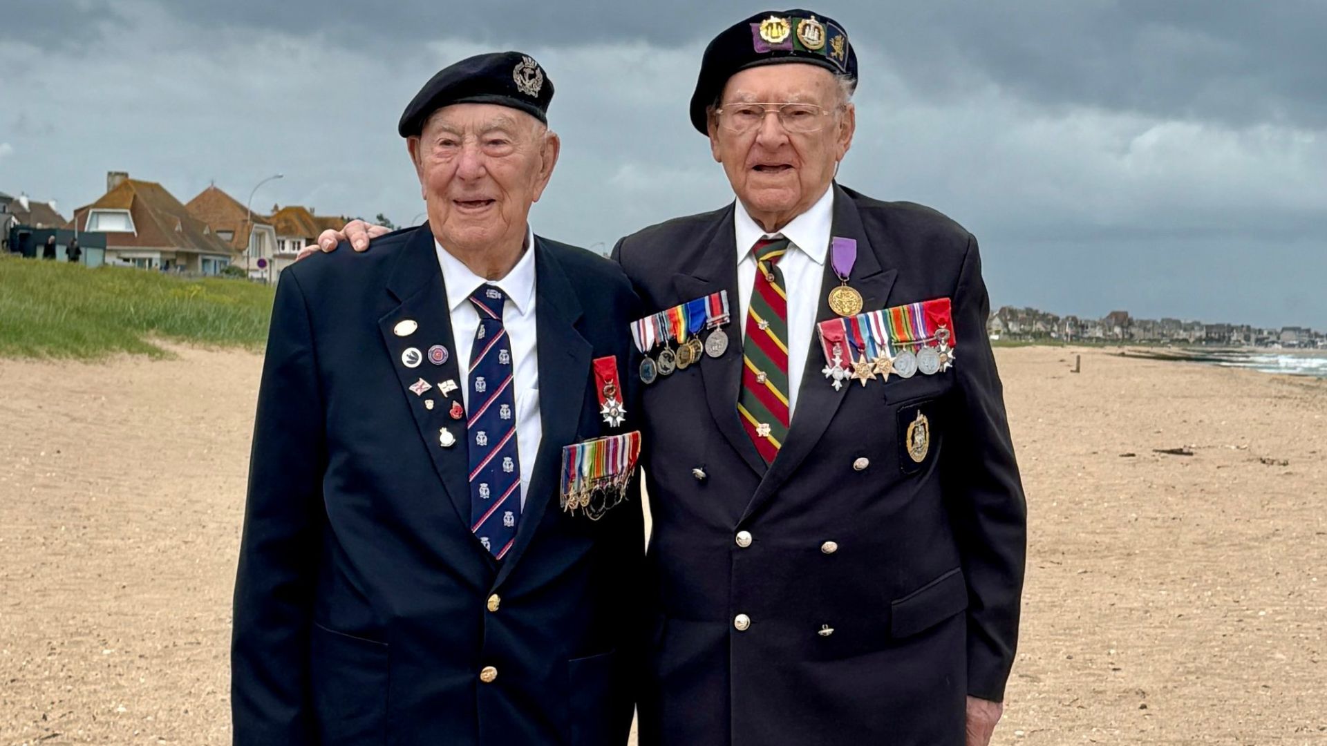 D-Day veterans Henry Rice (left) and Ken Hay MBE share a touching moment on Sword Beach (Picture: BFBS)