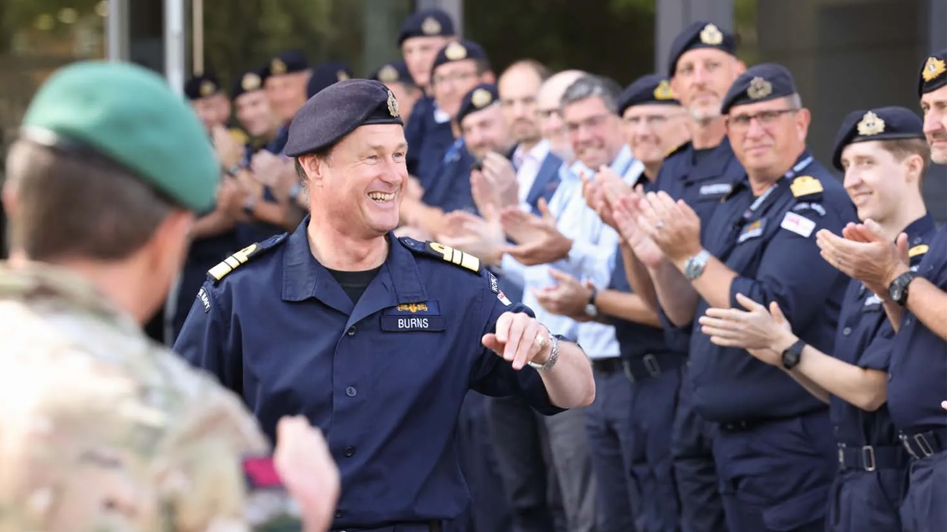 Departing Fleet Commander Admiral Andrew Burns is clapped by colleagues as he leaves Navy Command Headquarters at HMS Emsworth