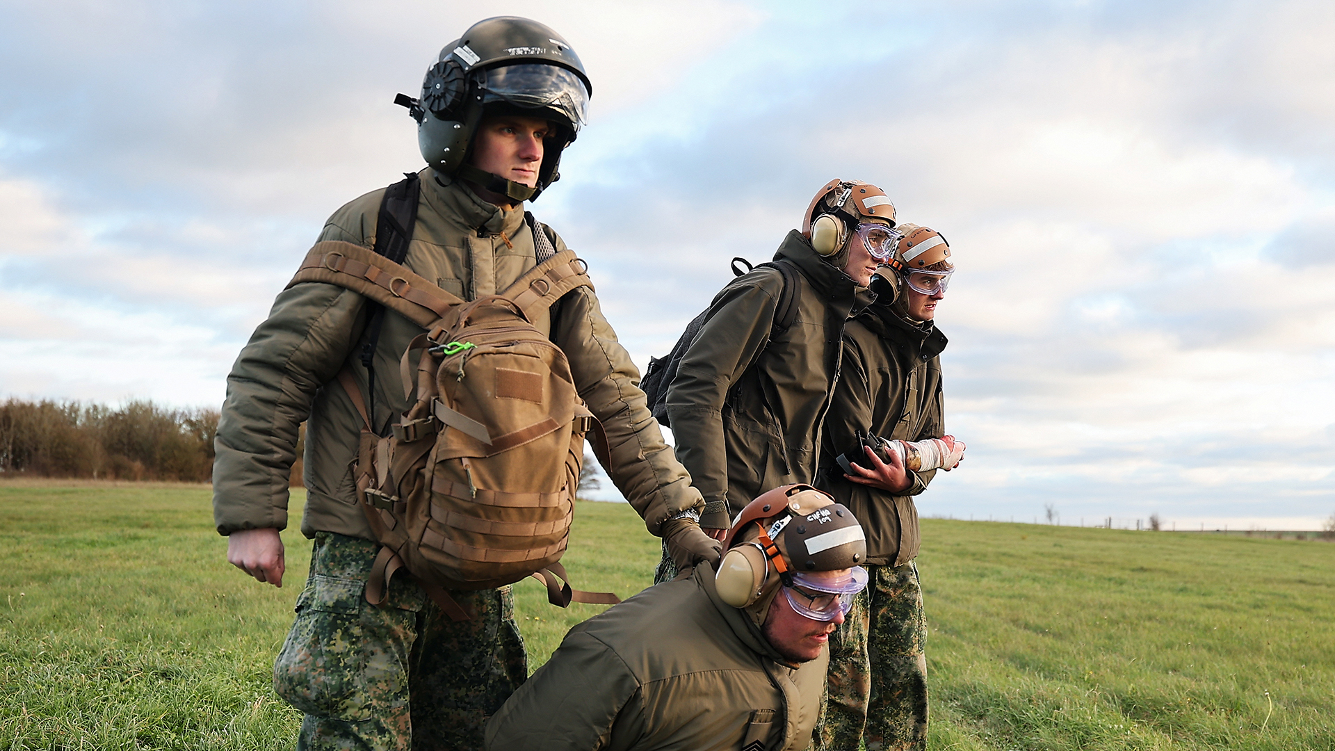 A Dutch crewman awaits the arrival of a helicopter to take away a captured enemy and a casualty