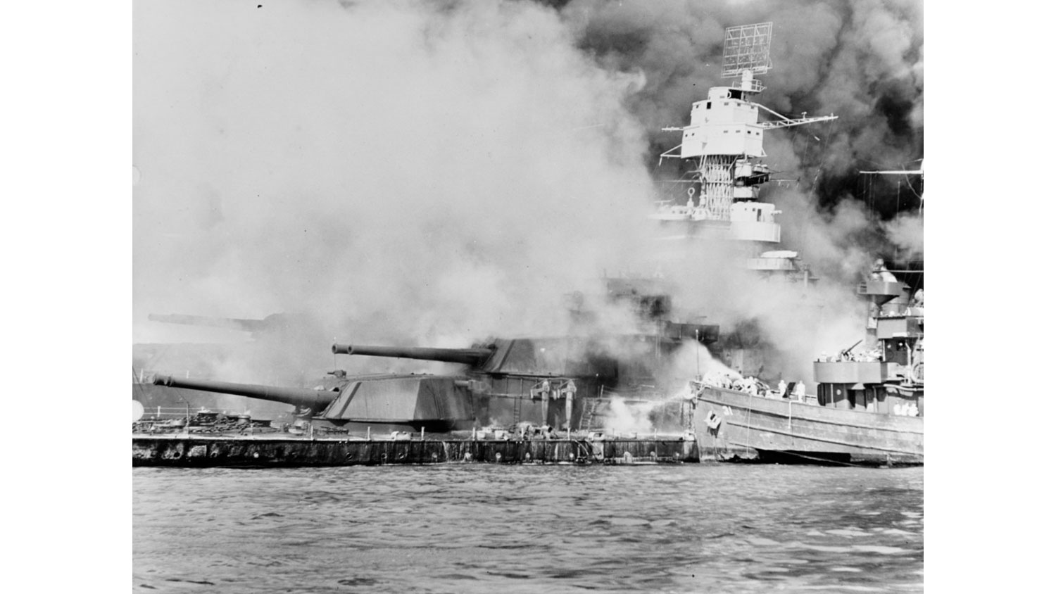 051225 USS Tern fighting fires on the sunken USS West Virginia, 7 December 1941, immediately after the Japanese attack CREDIT Naval History and Heritage Command