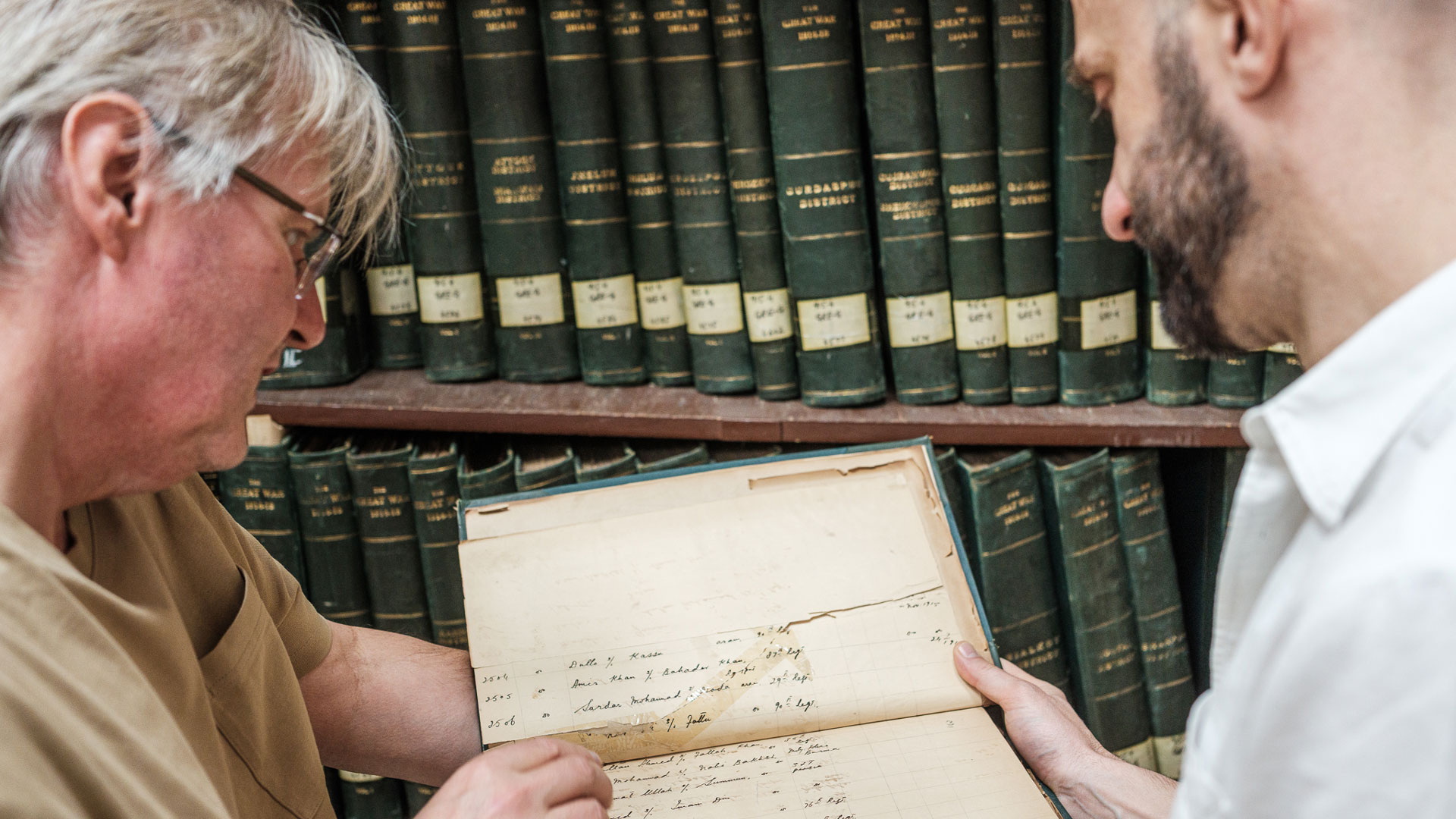  CWGC-funded PhD student, George Williams (left), examines the Punjab Registers with Professor Gavin Rand (right) from the University of Greenwich (Picture: CWGC)