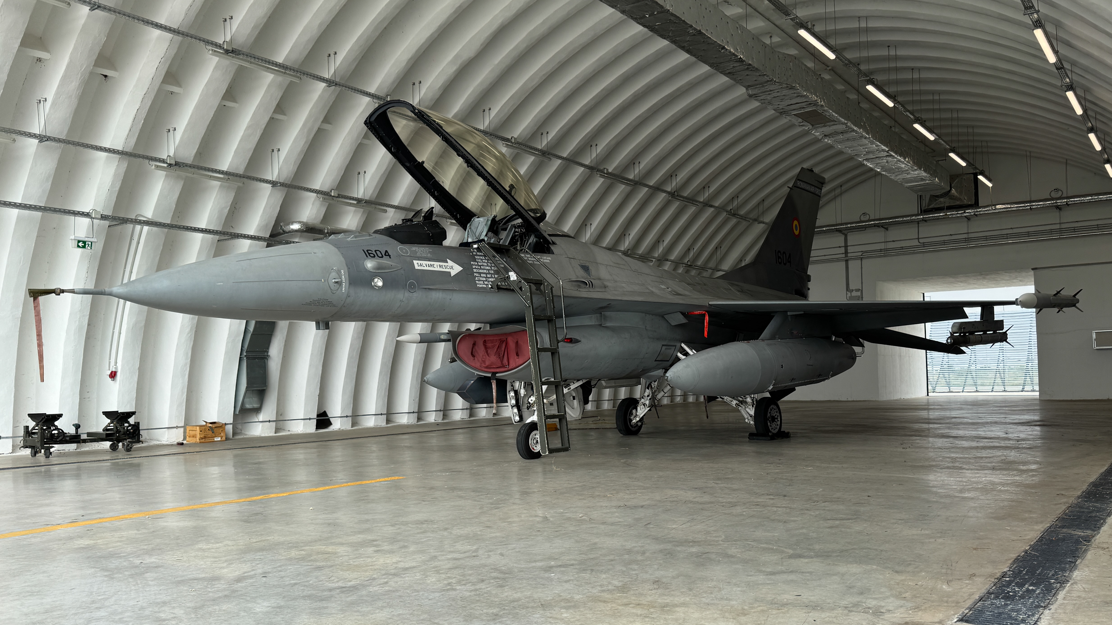 A Romanian Air Force F-16 fighter jet in a hangar