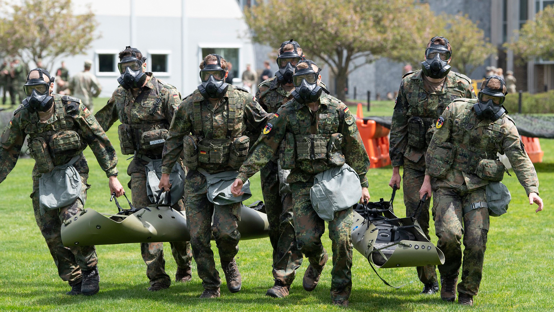 The 2026 Sandhurst Cup was a chance to bond - here the German team takes part in a casevac - gas masks may have come a long way, but are still hot to wear (Picture: US Department of War)