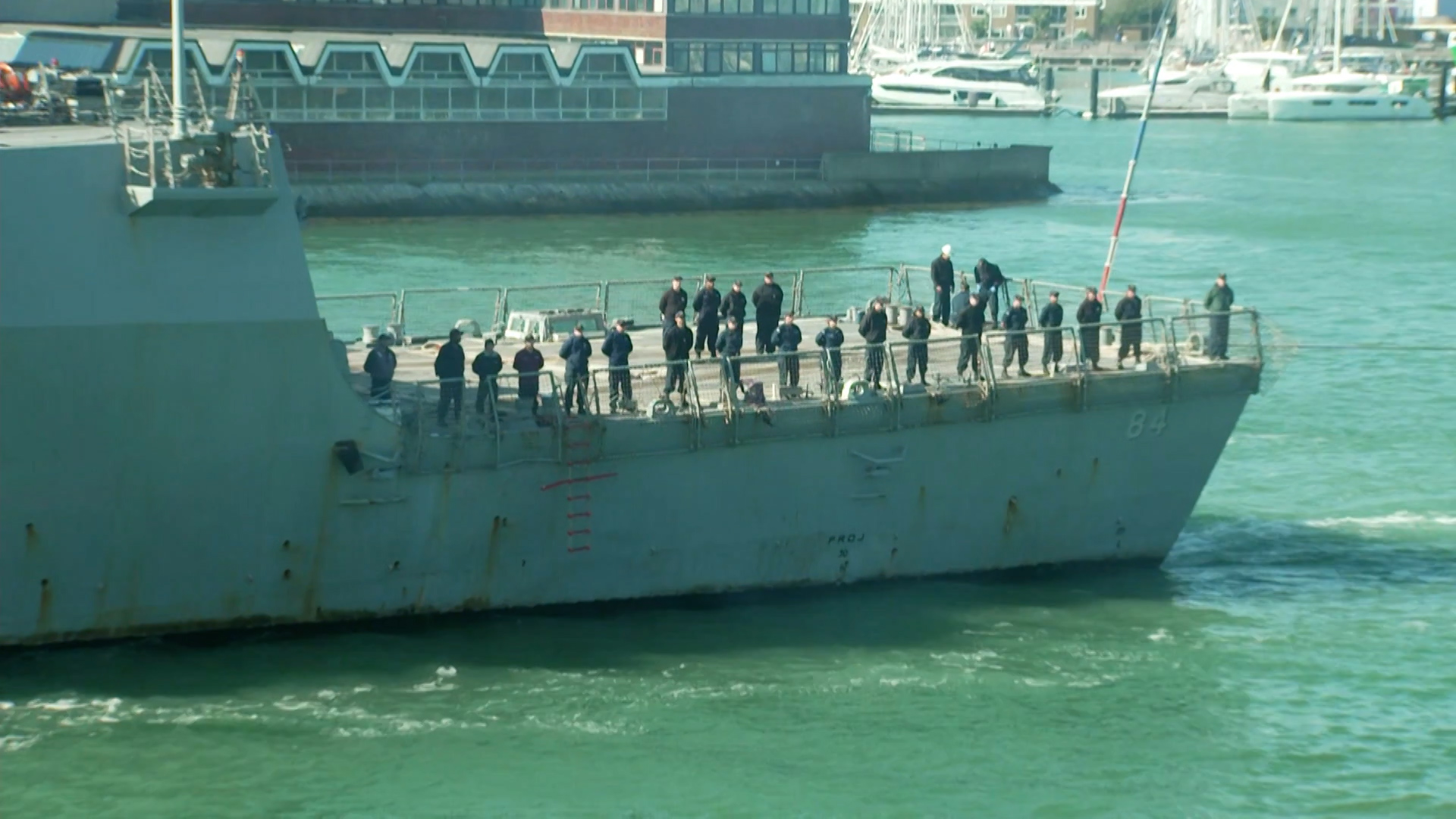 Crew members aboard US Bulkeley stood to attention as the vessel departed Portsmouth