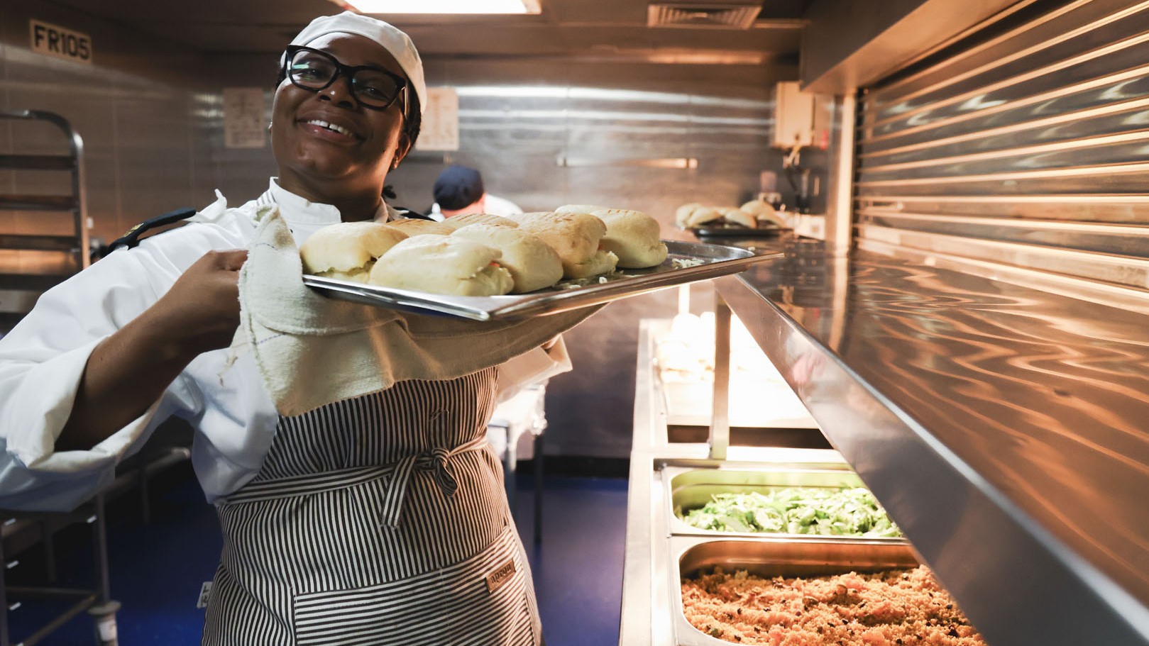 One of HMS Queen Elizabeth's chefs delivers fresh paninis pic MOD