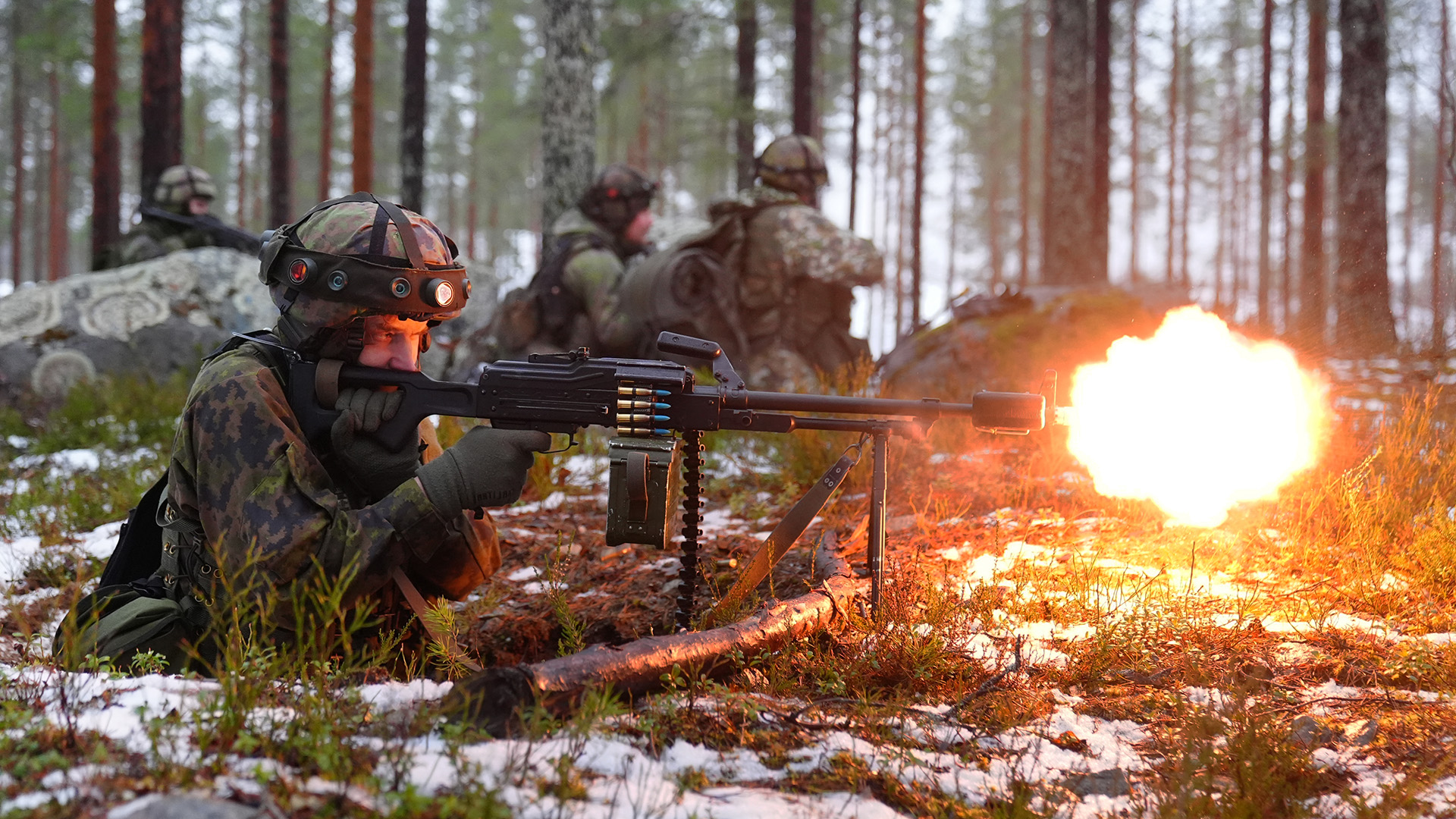 A Finnish soldier opens fire with his 7.62mm KK PKM light machine gun
