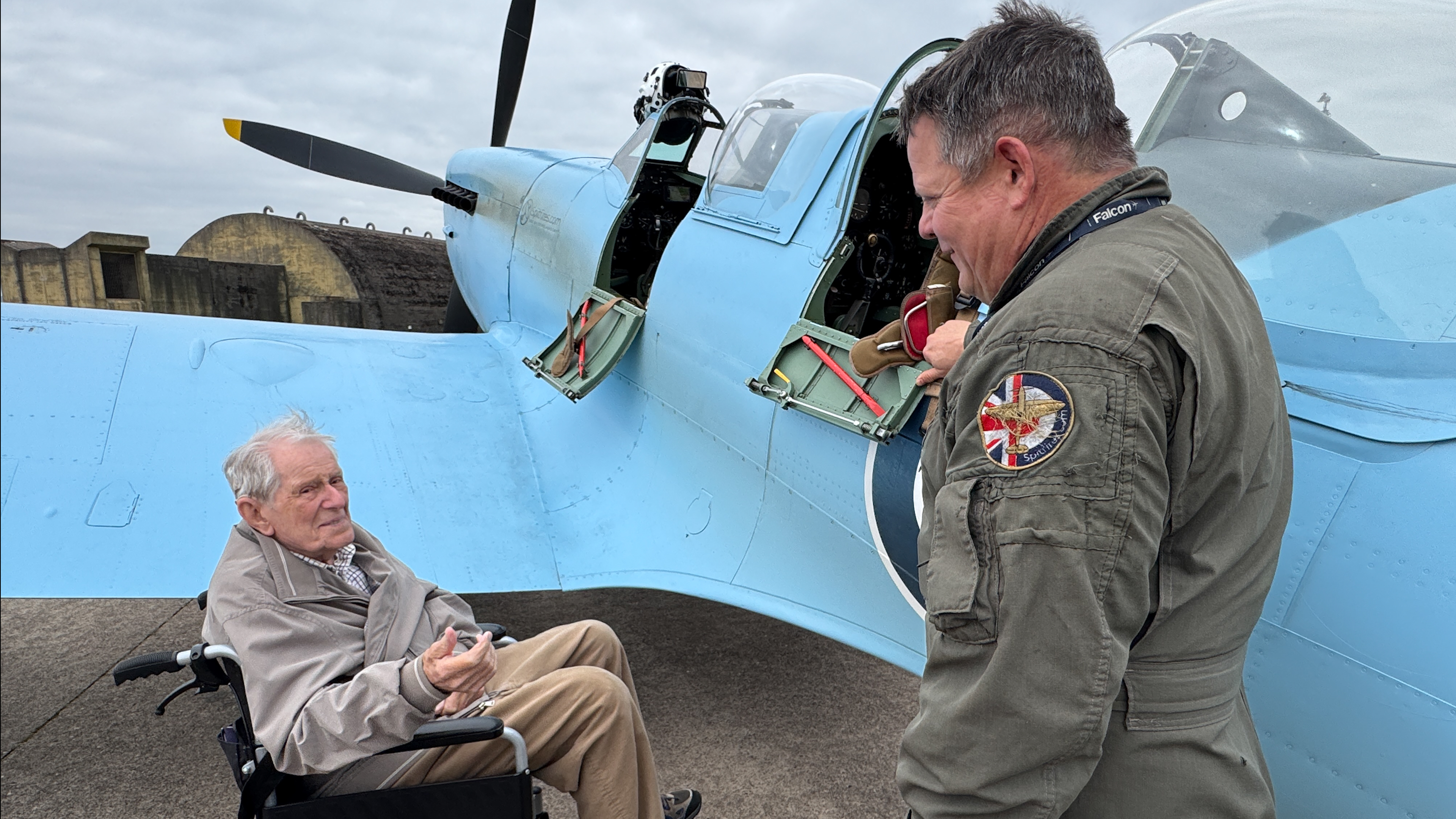 Former Spitfire pilot Douglas Seale chats with a pilot by a replica of the original protoype