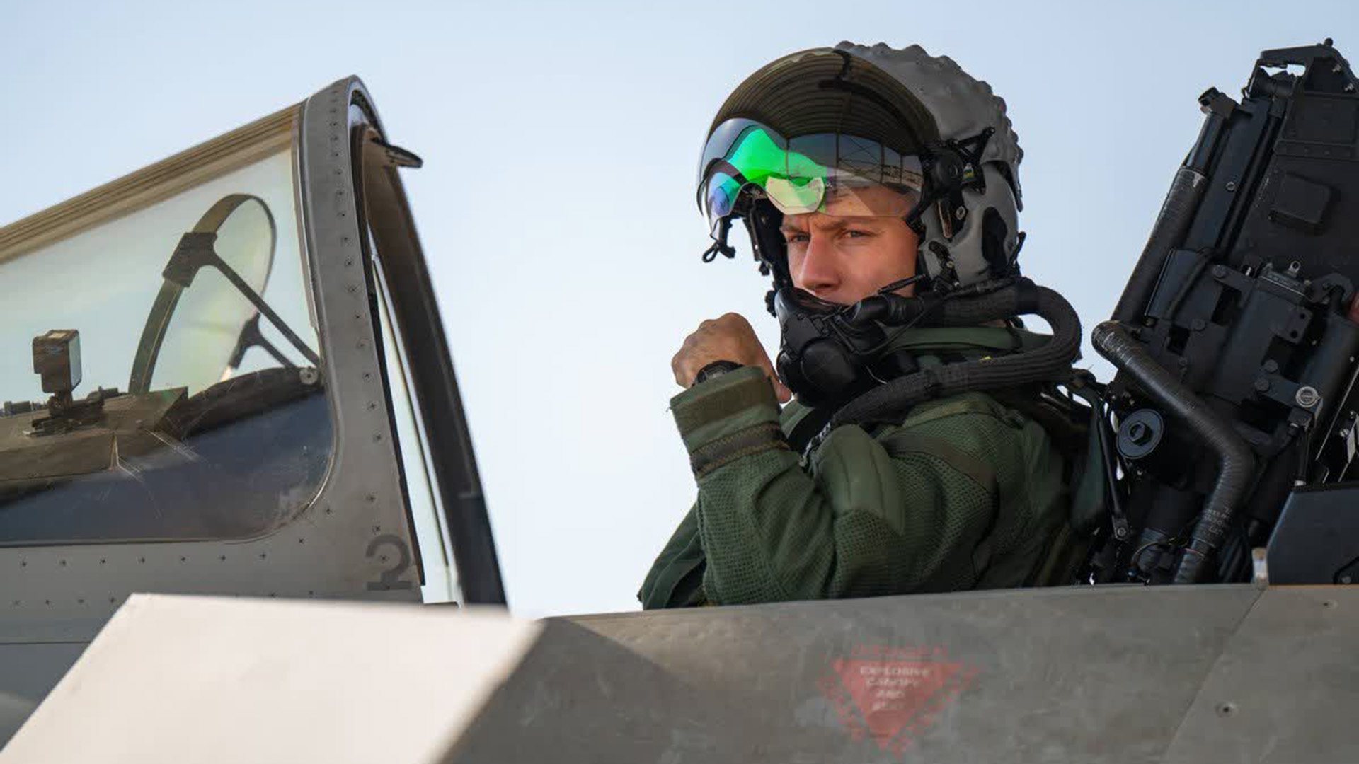 A pilot looks out from the cockpit of his aircraft in Saudi Arabia