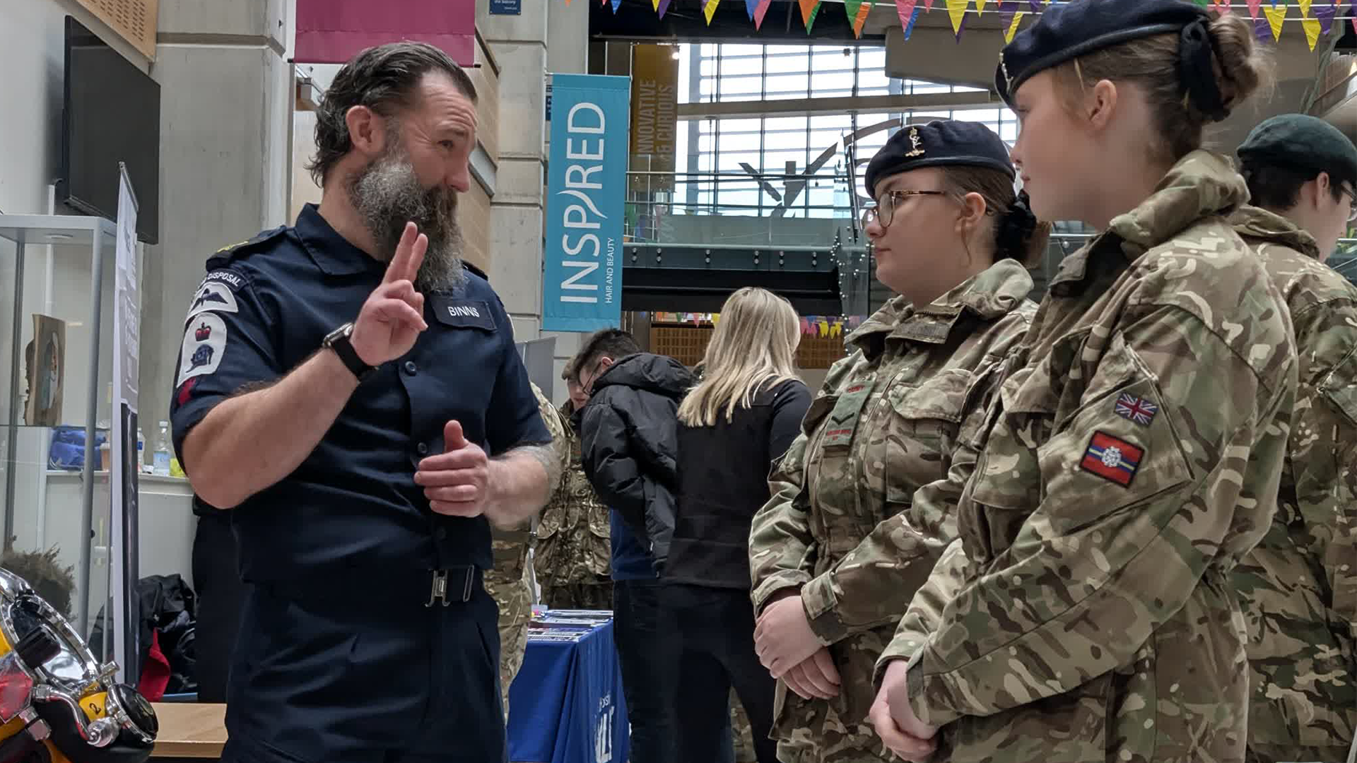 Service personnel talk through career options with cadets considering life after school