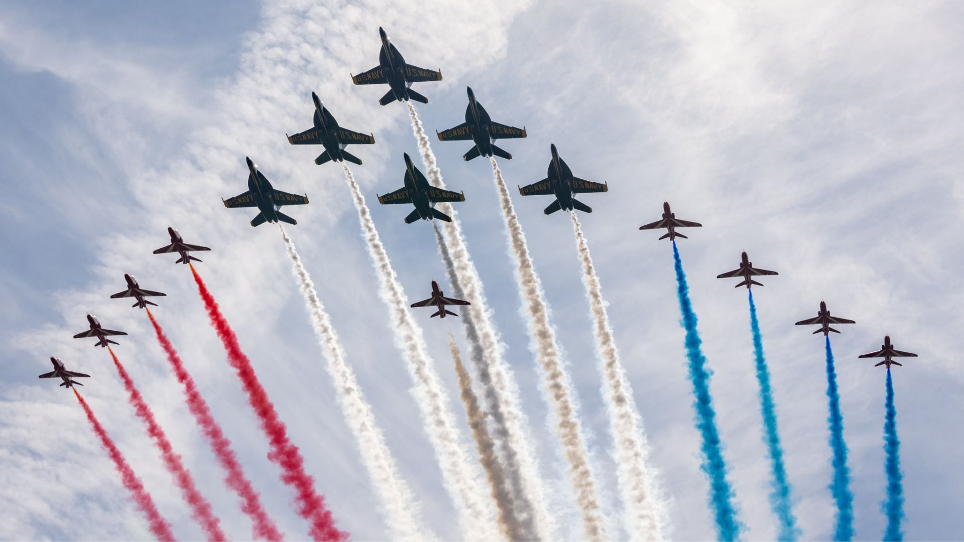 The Red Arrows perform a mixed formation flypast with their US Navy counterparts the Blue Angels in Maine as they continue their US tour marking 250 years since the declaration of independence