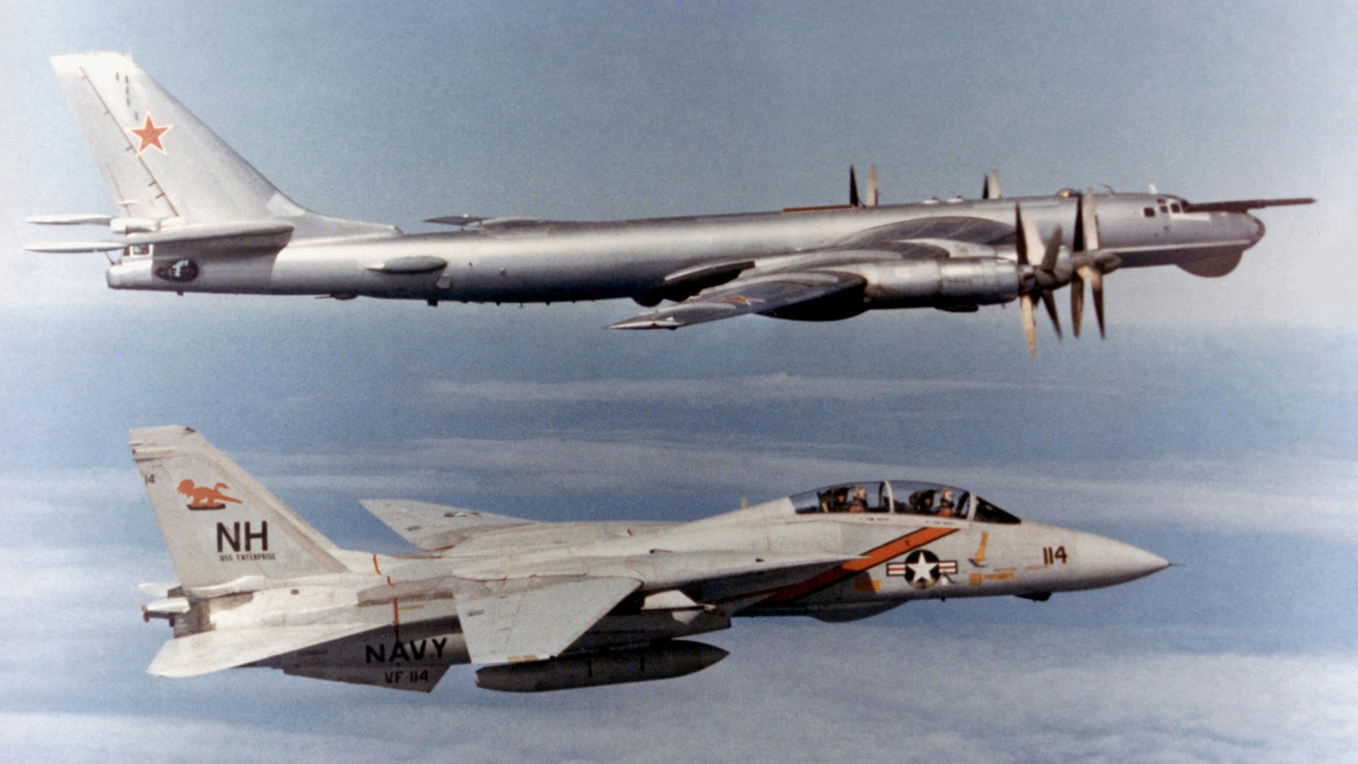 A Russian Tu-95 Bear bomber is shadowed by a US Navy F-14 Tomcat - a scene that's still being played out today, albeit with different Nato fighters (Picture: Alamy)