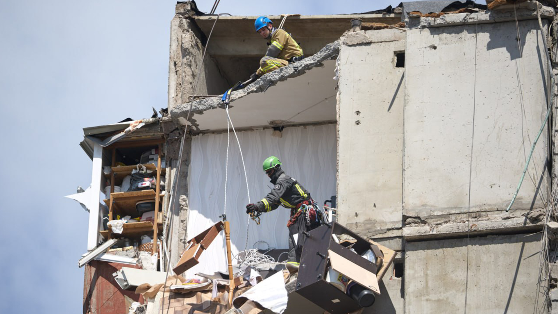 The rescue workers needed to be mindful of their own safety when operating in the upper storeys of numerous stricken apartment blocks (Picture: President Zelensky Telegram)