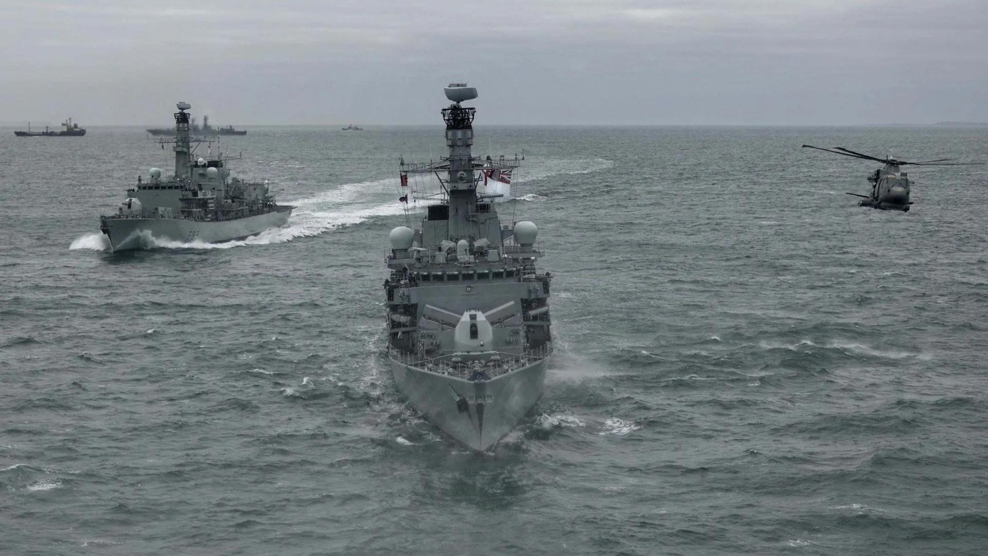 HMS Somerset flanked by HMS St Albans and Merlin helicopter while escorting Russian vessels CREDIT Royal Navy