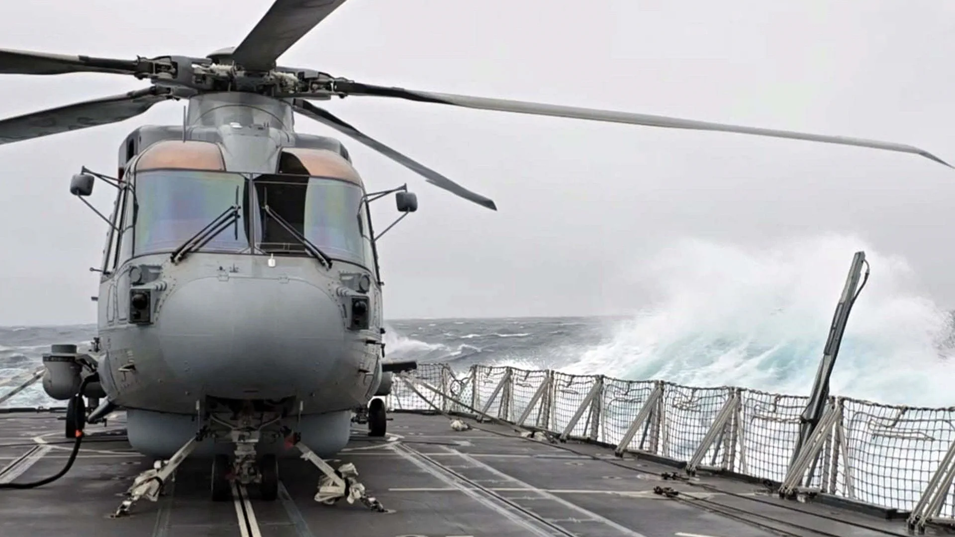 Merlin withstands wind and waves on HMS Somerset's flight deck CREDIT ROYAL NAVY