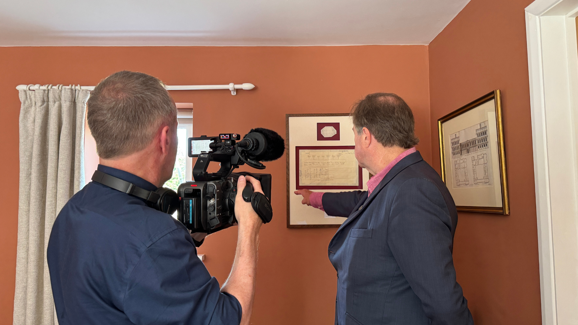 Viscount Mark Slim shows BFBS the framed seating plan from Japan's surrender at Singapore, complete with his grandfather's nameplate from the historic meeting
