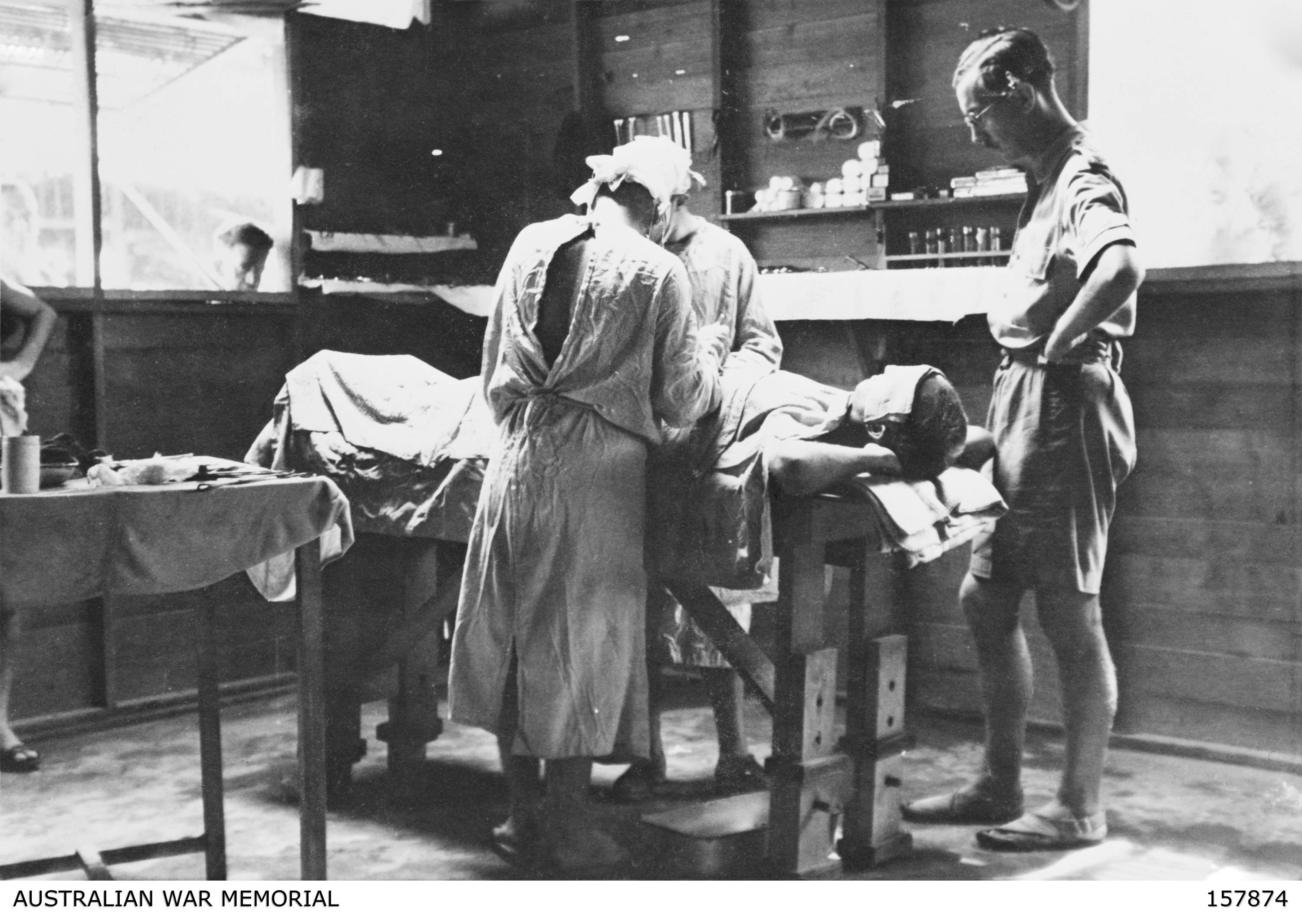 A surgical operation in progress in the operating theatre at the prisoner of war (POW) hospital camp. Of the 896 operations which were performed here there was a mortality rate of 18. Credit: Australian War Memorial - 157874