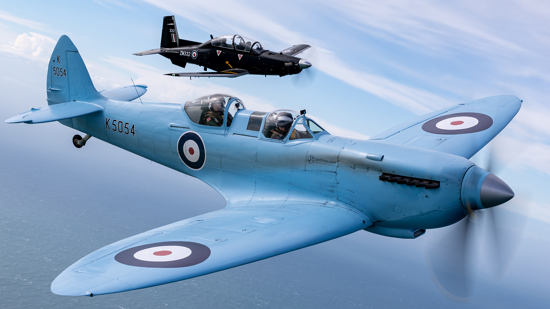 The Spitfire TR9, in the colours and markings of protoptype K5054, forms up with a Texan T1 from MOD St Athan