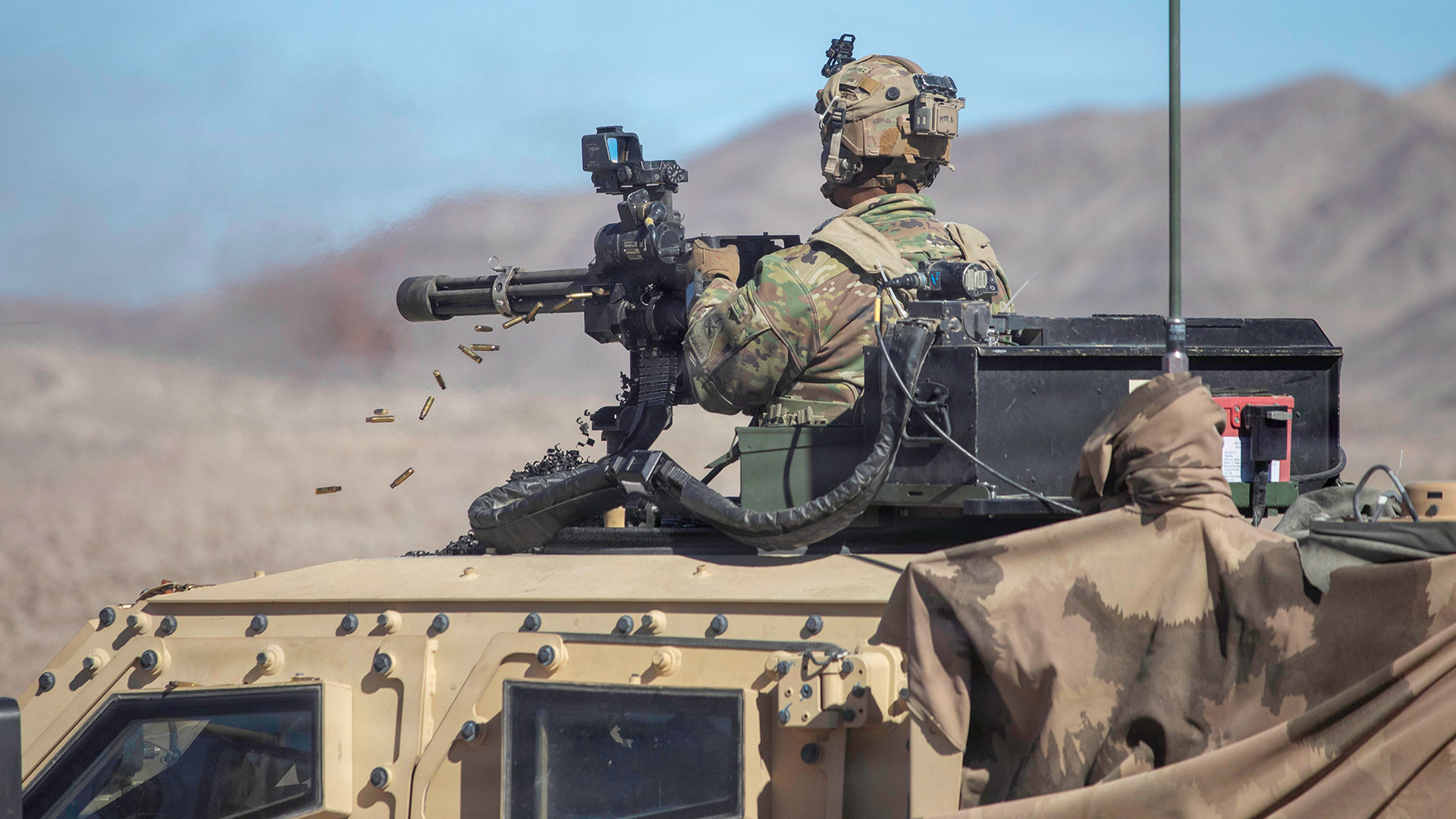 This US soldier is opening fire with an M134 mounted to an Oshkosh L-ATV light combat tactical all-terrain vehicle