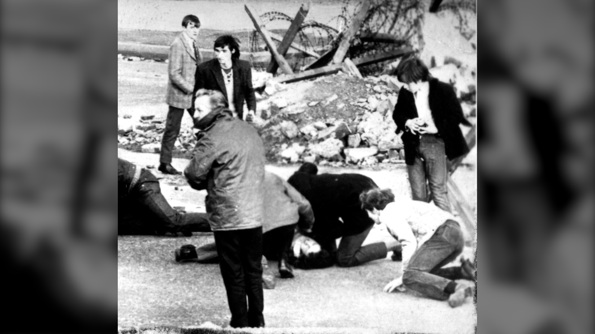 Man receiving attention during shooting incident in Londonderry, NI, - Bloody Sunday 31/01/72