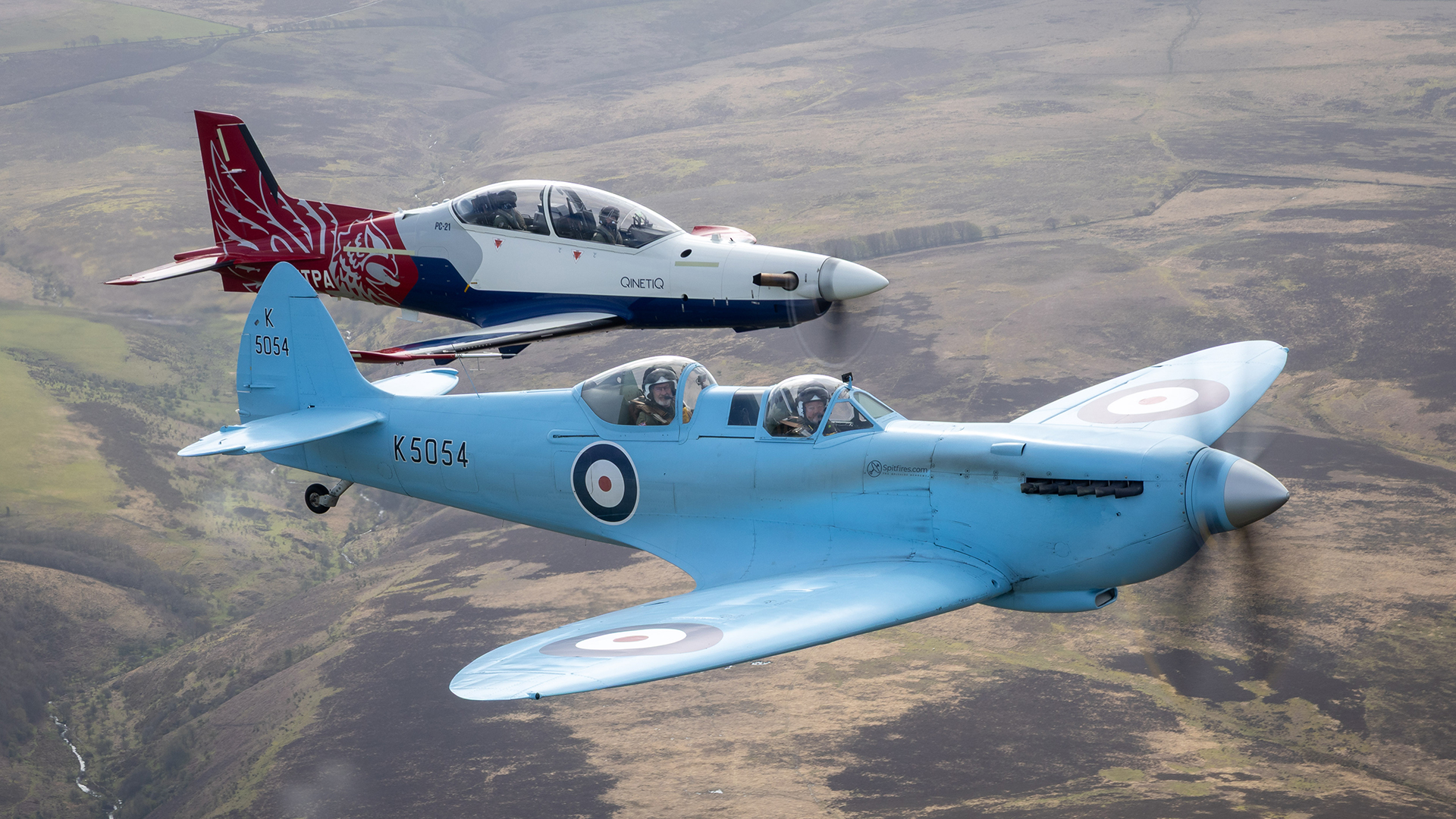 The Spitfire TR9 flies alongside the only civilian aircraft to take part in the round-Britain tour, a Pilatus PC-21 operated by QinetiQ