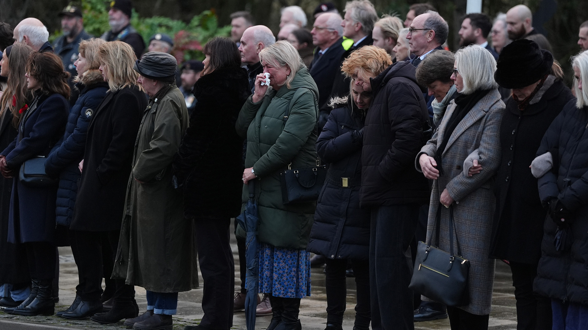 Members of the public pay their respects as the cortege carrying the body of Lance Corporal George Hooley passes the Memorial Garden in Carterton