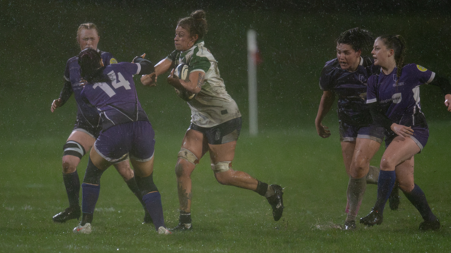Ellie Brightwell pushing through rain and tackles for Navy women rugby Credit Windandsurf Images.jpg