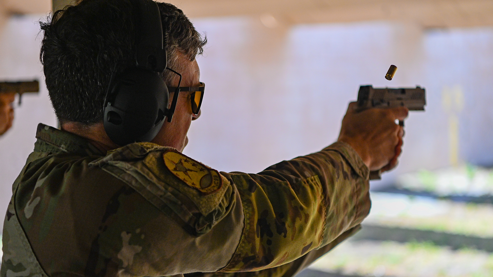 A US Air Force technical sergeant takes part in a pistol competition with his M18 - the fatal shooting also involved a member of the USAF