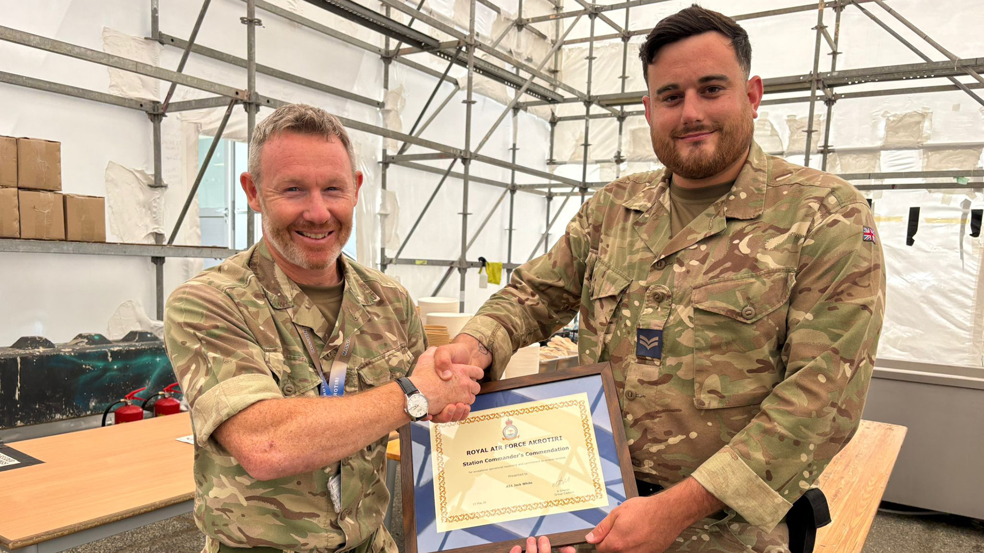 Wing Commander Ade Mellors shakes Corporal Jack White's hand as he presents him with his award (Picture: BFBS)