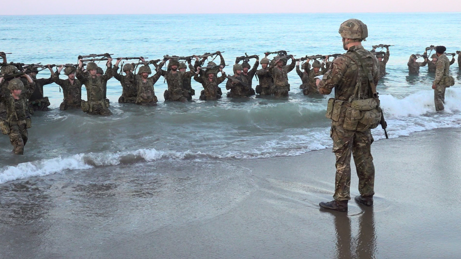 The Princess of Wales's Royal Regiment train on a beach in Cyprus, soldiers in the sea