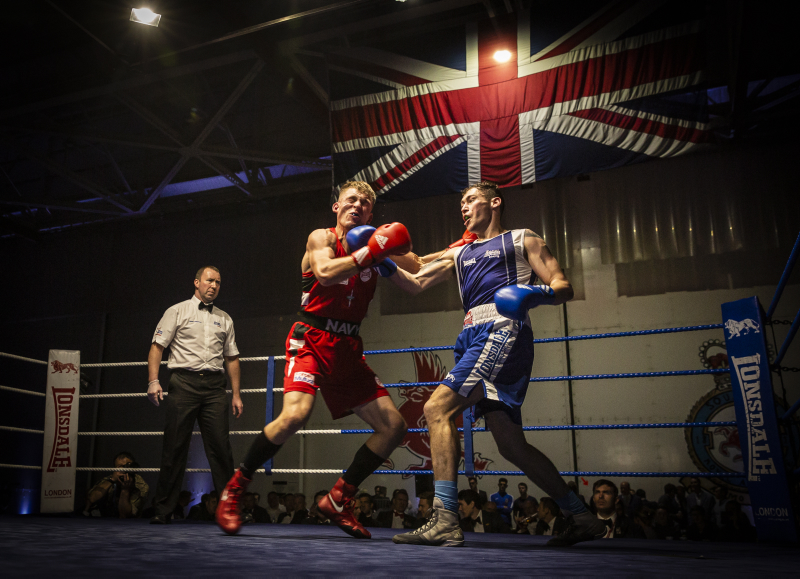 SAC (Senior aircraftman) Arran Devine (right), delivers a powerful uppercut on his Royal Marine opponent (left).