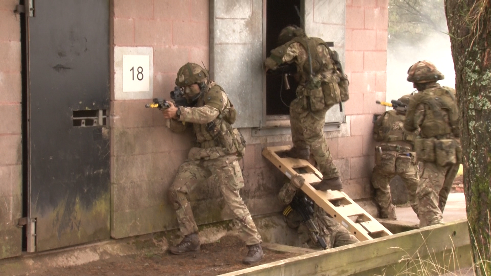 Soldiers clear and secure a building in 'Cellini Village'.