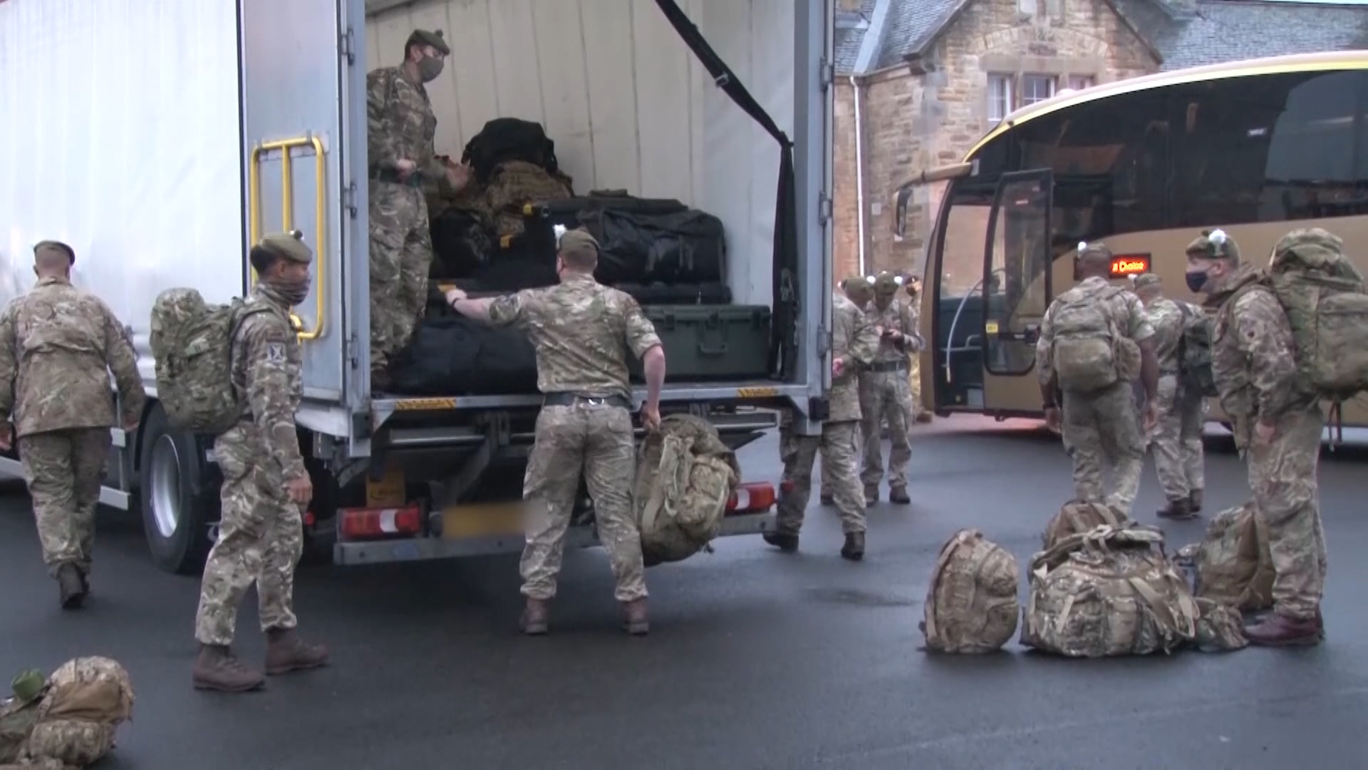 Soldiers load their bergens onto a lorry ahead of heading south to RAF Wittering.