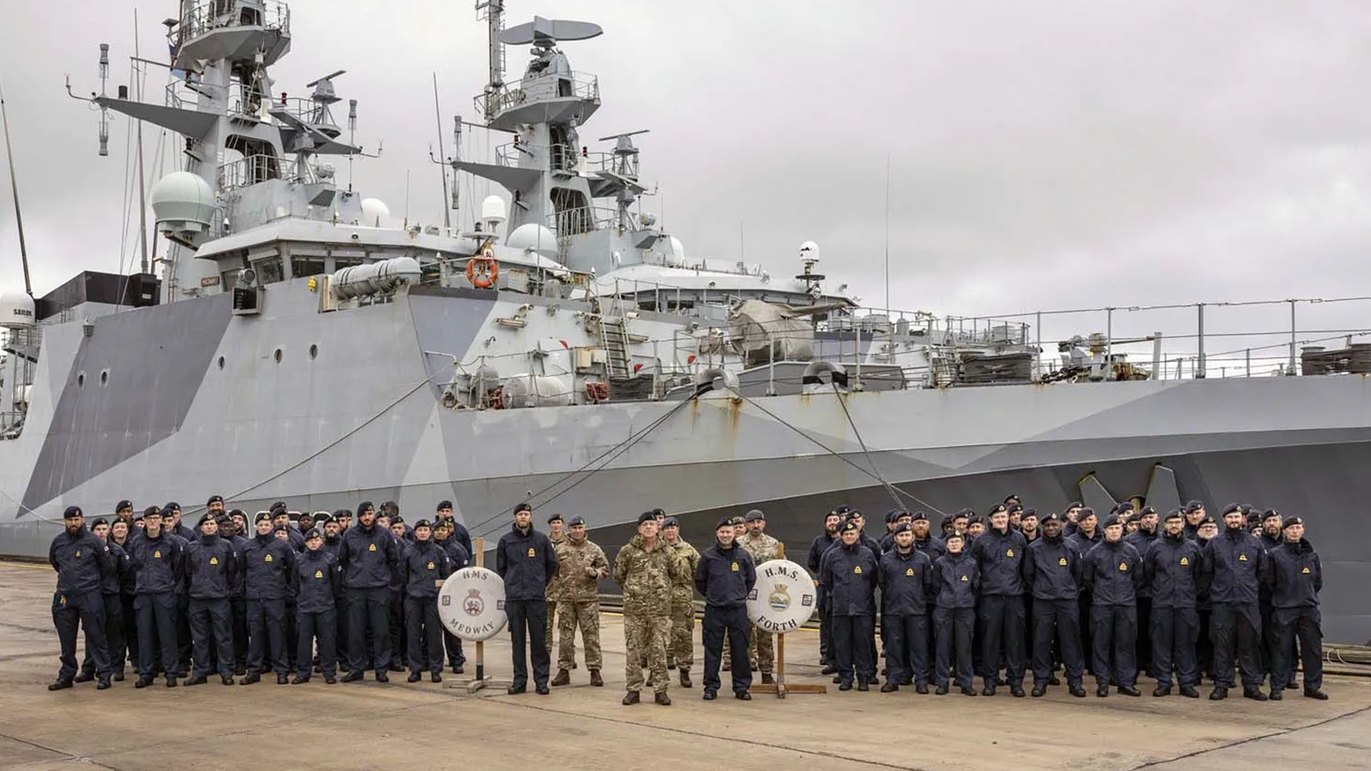 The crews of HMS Medway and Forth pose with their ships