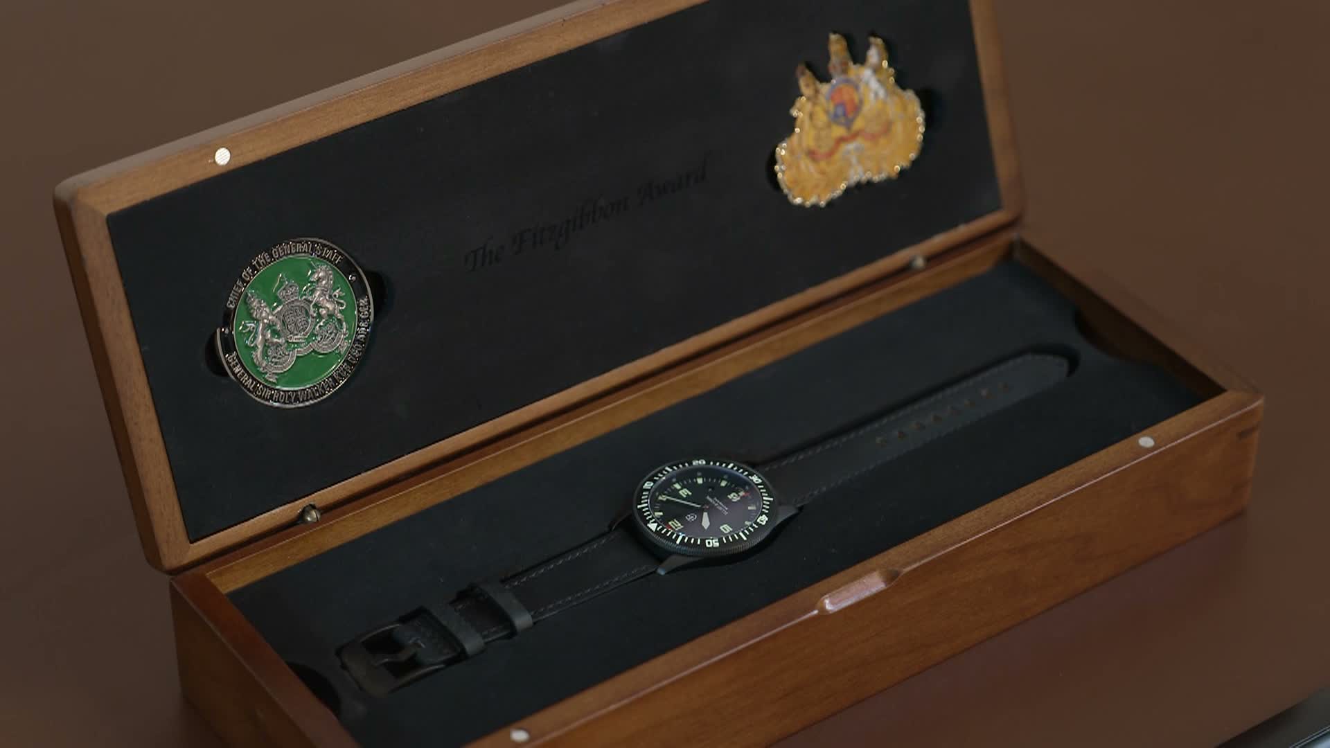 The winner receives an engraved black plastic watch with their name and a special citation