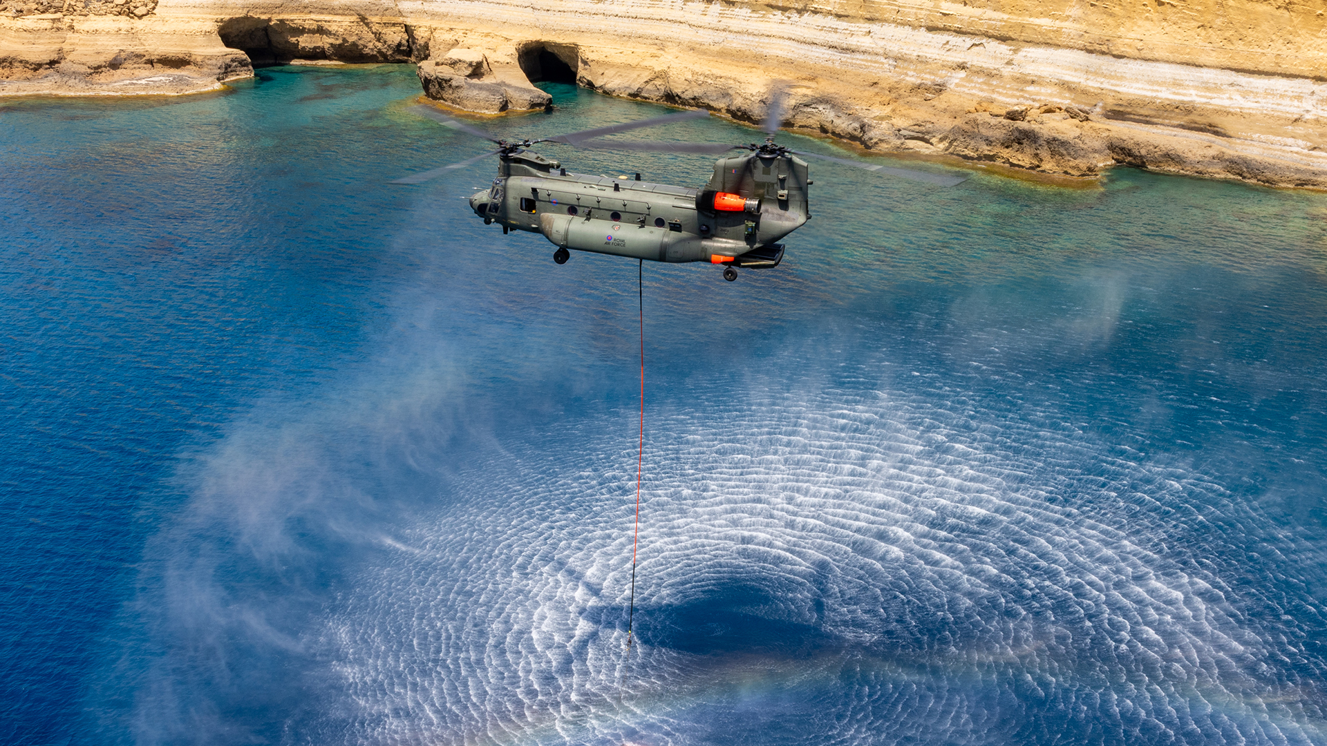 A firefighting Chinook from 1310 Flight fills its Bambi bucket with water during a training sortie ahead of this year's wildfire season in Cyprus (Picture: MOD)