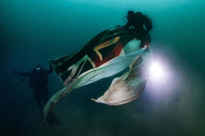 Royal Navy divers carry White Ensign to site of HMS Royal Oak