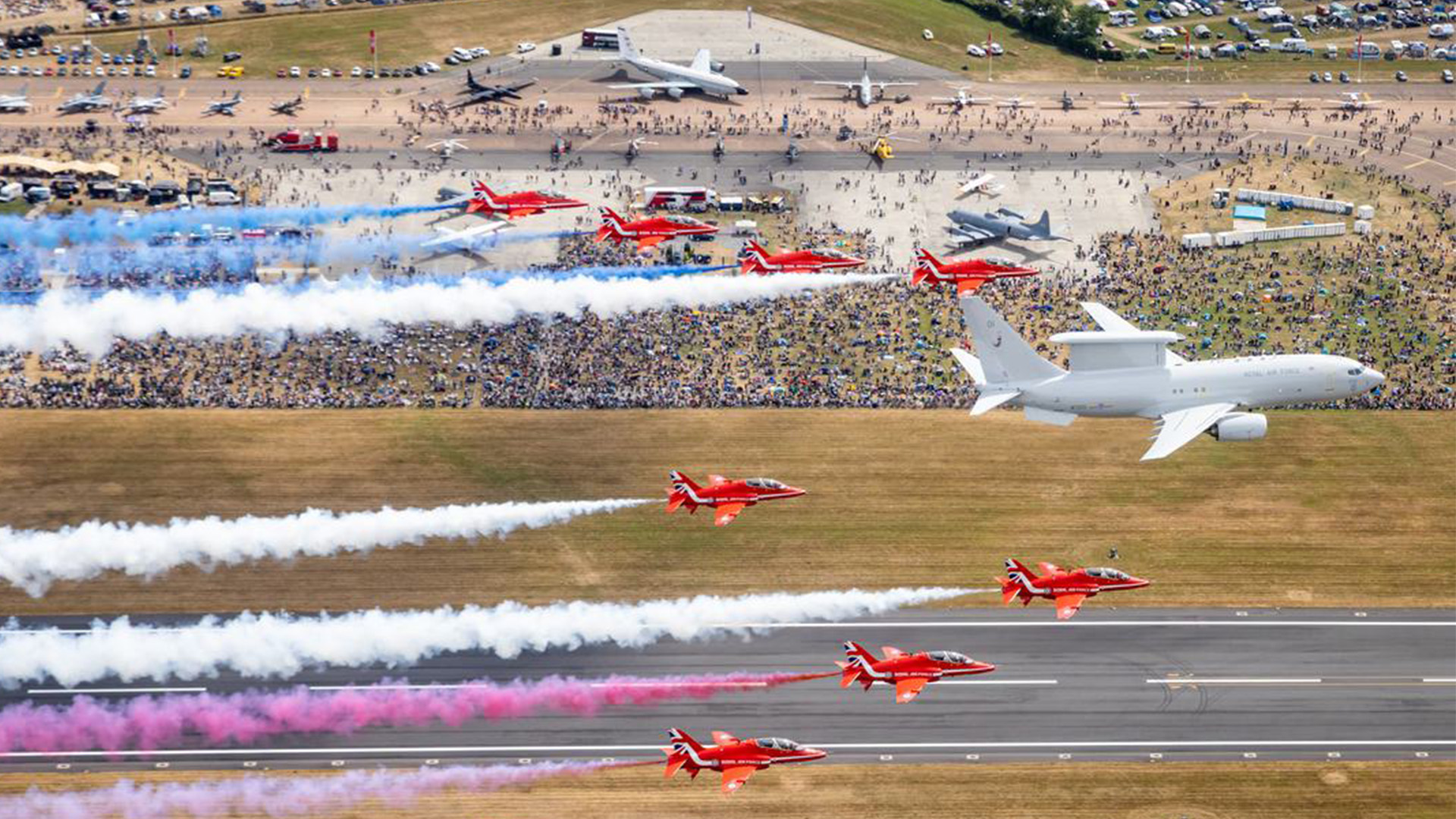 The Red Arrows team trailed red, white and blue smoke as they flew over RAF Fairfor