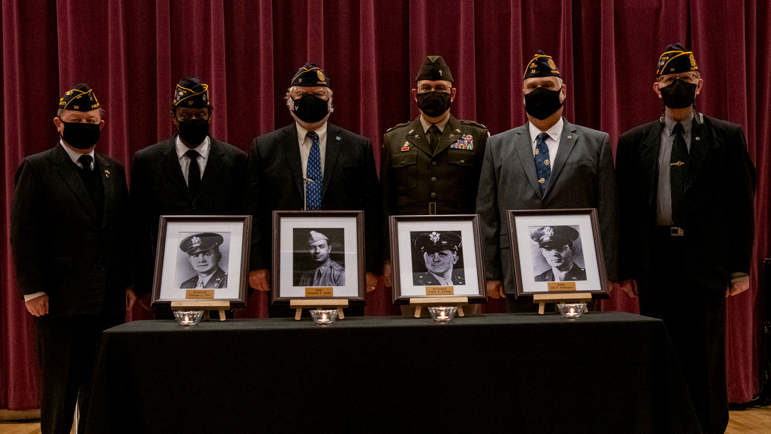 030226 veterans stand with photos of the Four Chaplains during a ceremony honouring their sacrifice at the US Army Garrison Humphreys Four Chaplains Memorial Chapel in February 2022 CREDIT US Army