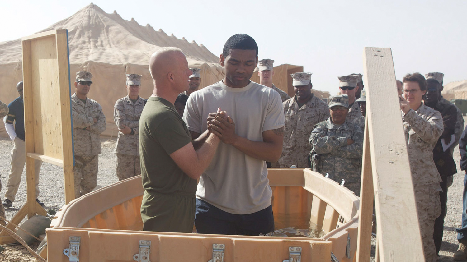 030226 Chaplain Christopher Earley prepares to baptize US Navy Lt Kelvin Boatner at Camp Dwyer, Afghanistan on 25 Dec 2010 CREDIT US Marines