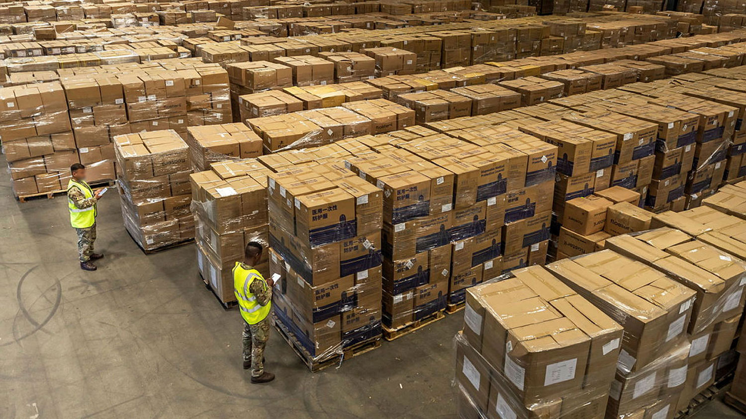 Members of 4 General Support Regiment, Royal Logistic Corps, check serial numbers on boxes within Clippers Logistics warehouse
