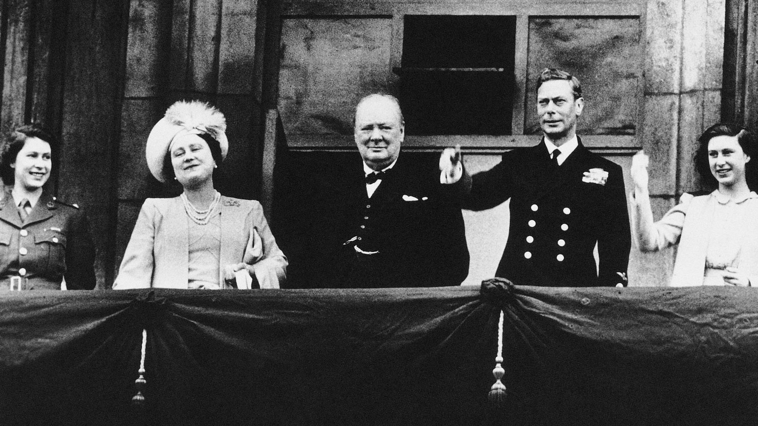 Princess Elizabeth, Queen Elizabeth the Queen Mother, Winston Churchill, King George VI and Princess Margaret on the Buckingham Palace balcony on VE Day 1945